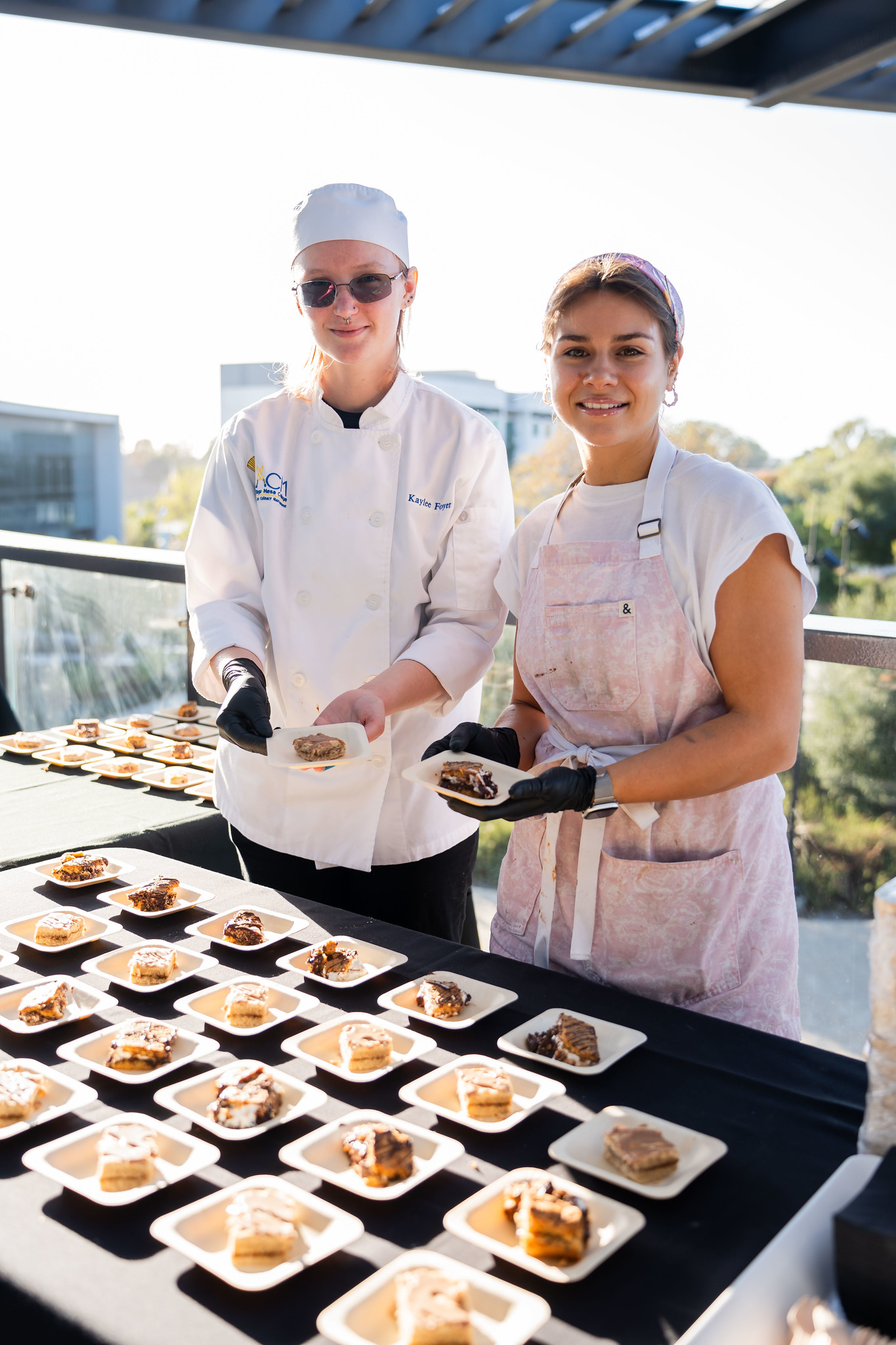 
Two chefs serving up samples.
