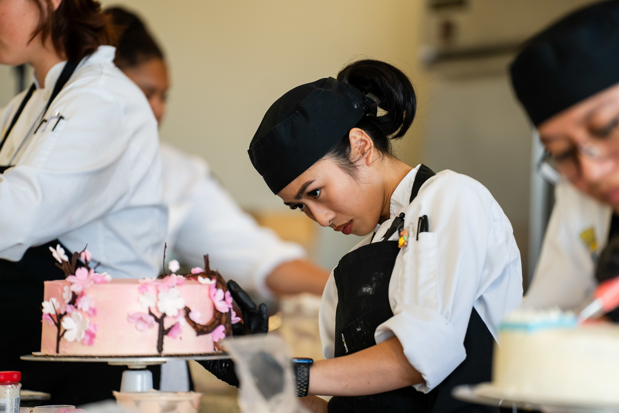 
Trisha Andres decorating her pink cherry blossom cake.
