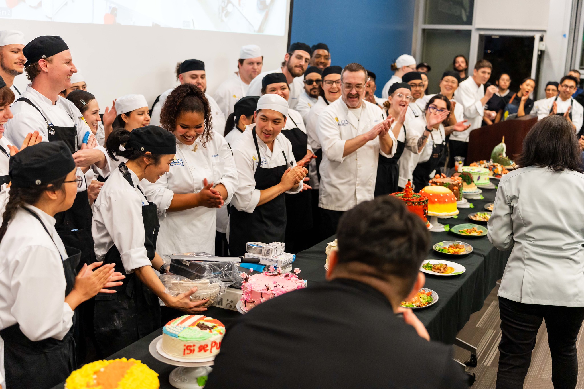 
All the chefs applaud Trisha Andres when it's announced that she won the cake baking contest.
