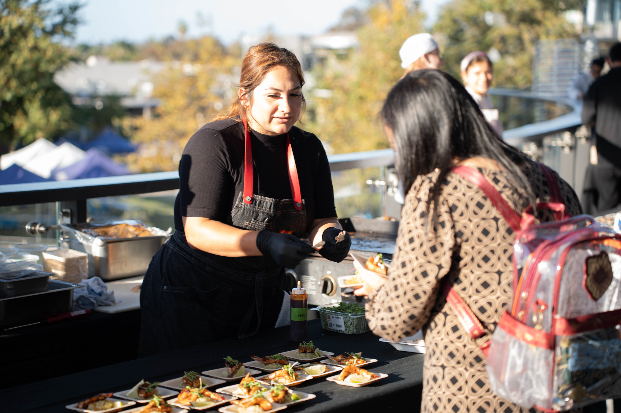 
A chef explains the tasting sample to a guest.
