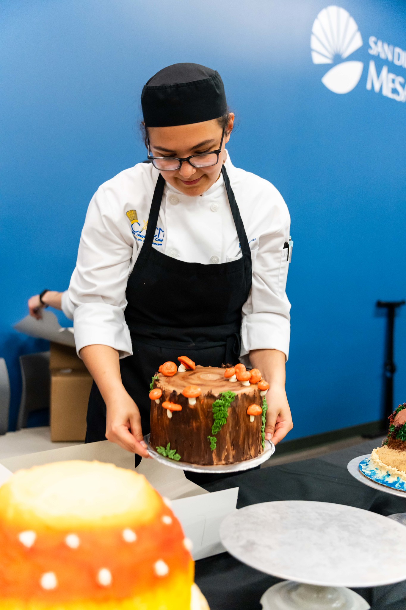 
A chef shows off her cake.
