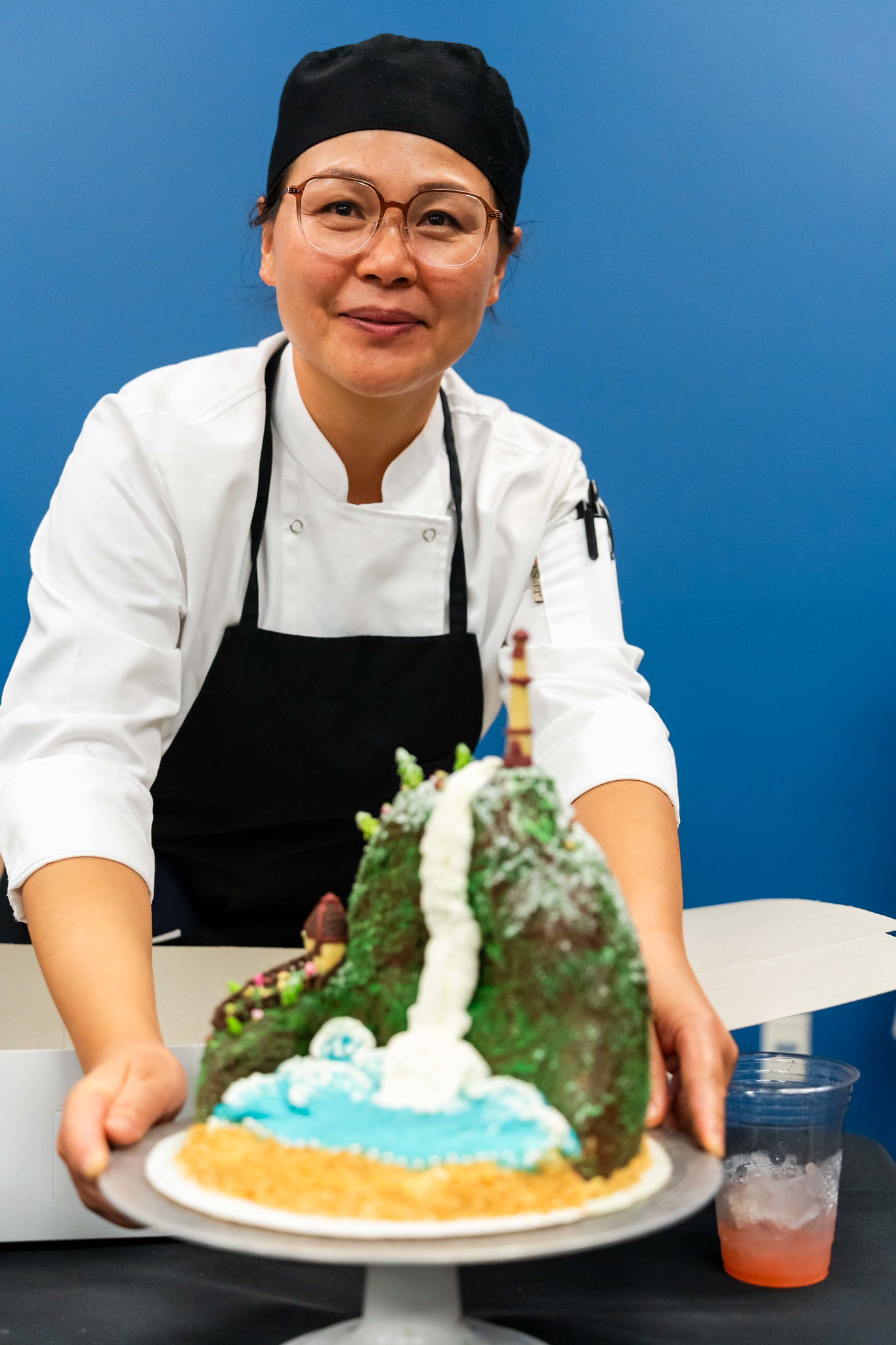 
A chef shows off her cake.
