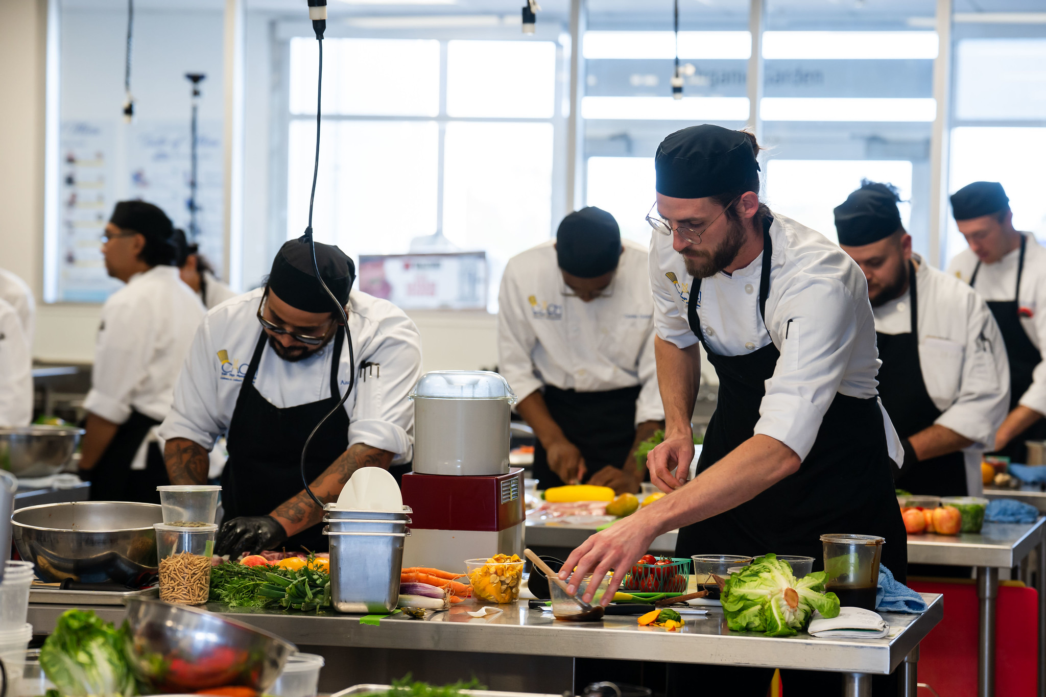 
Two chefs plating food in the prep area.
