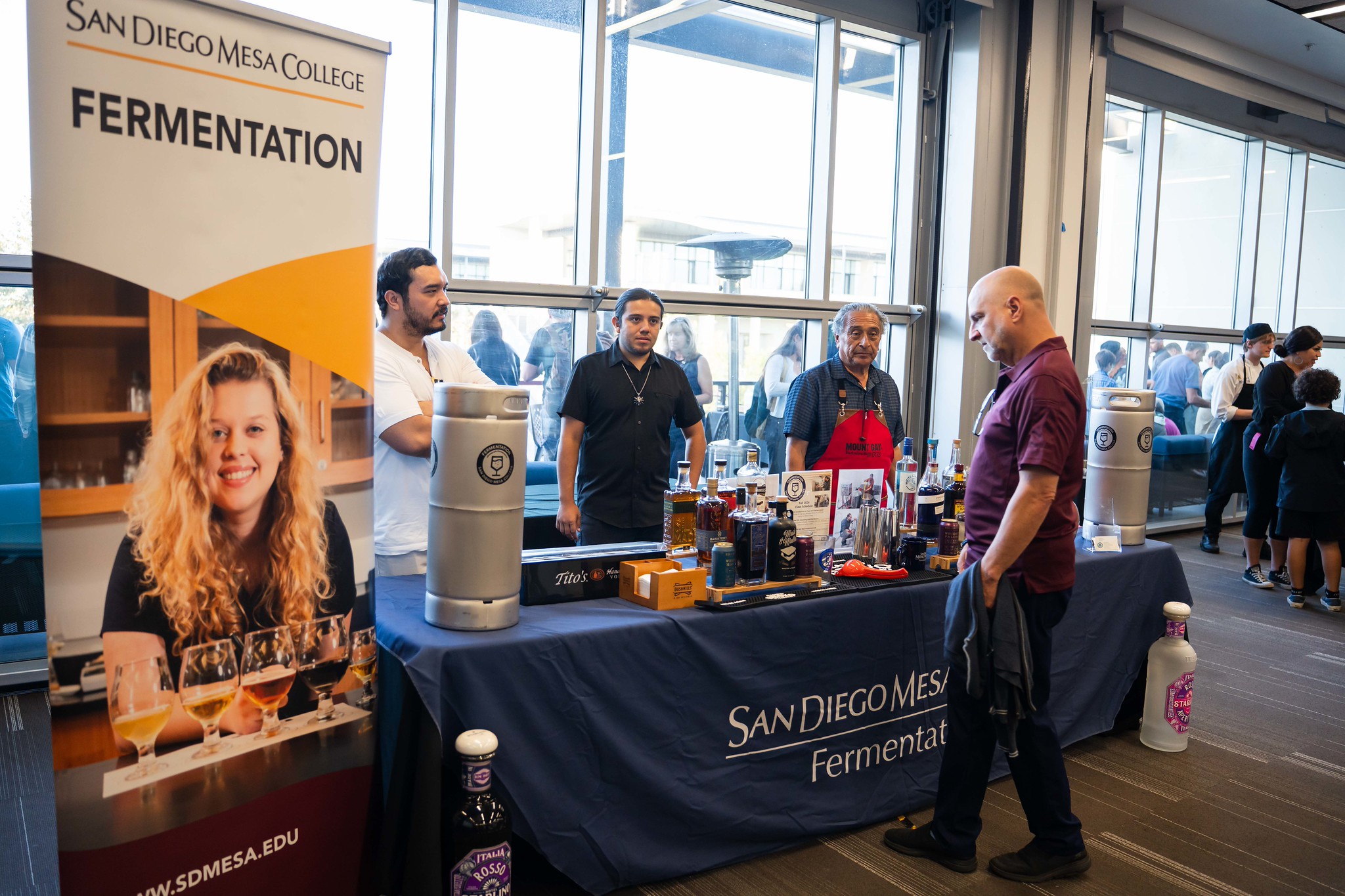 
A guest stops by a table to check out the fermentation program at Mesa College. 
