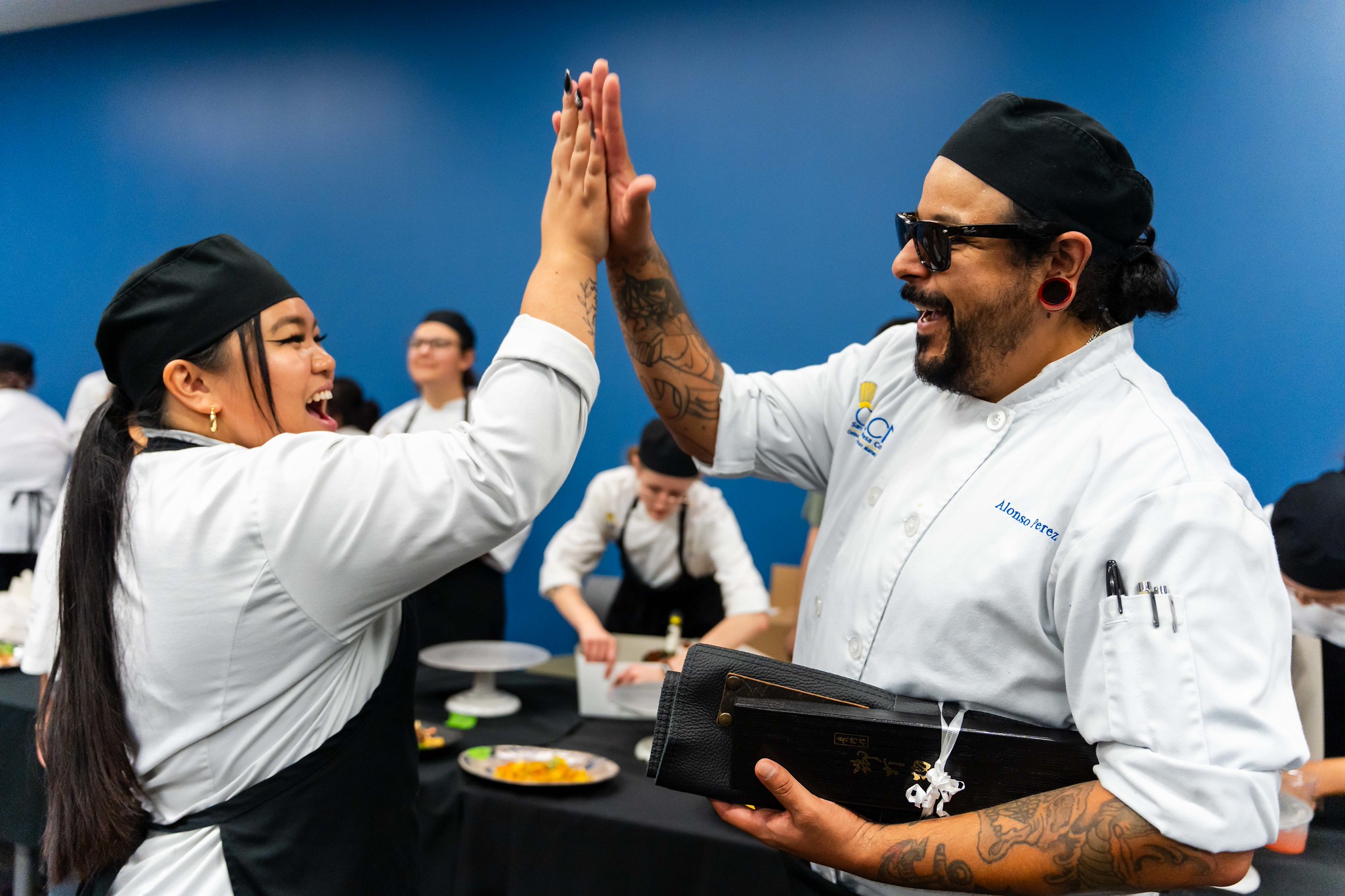 
The winner of the best dish high-fives another chef. 
