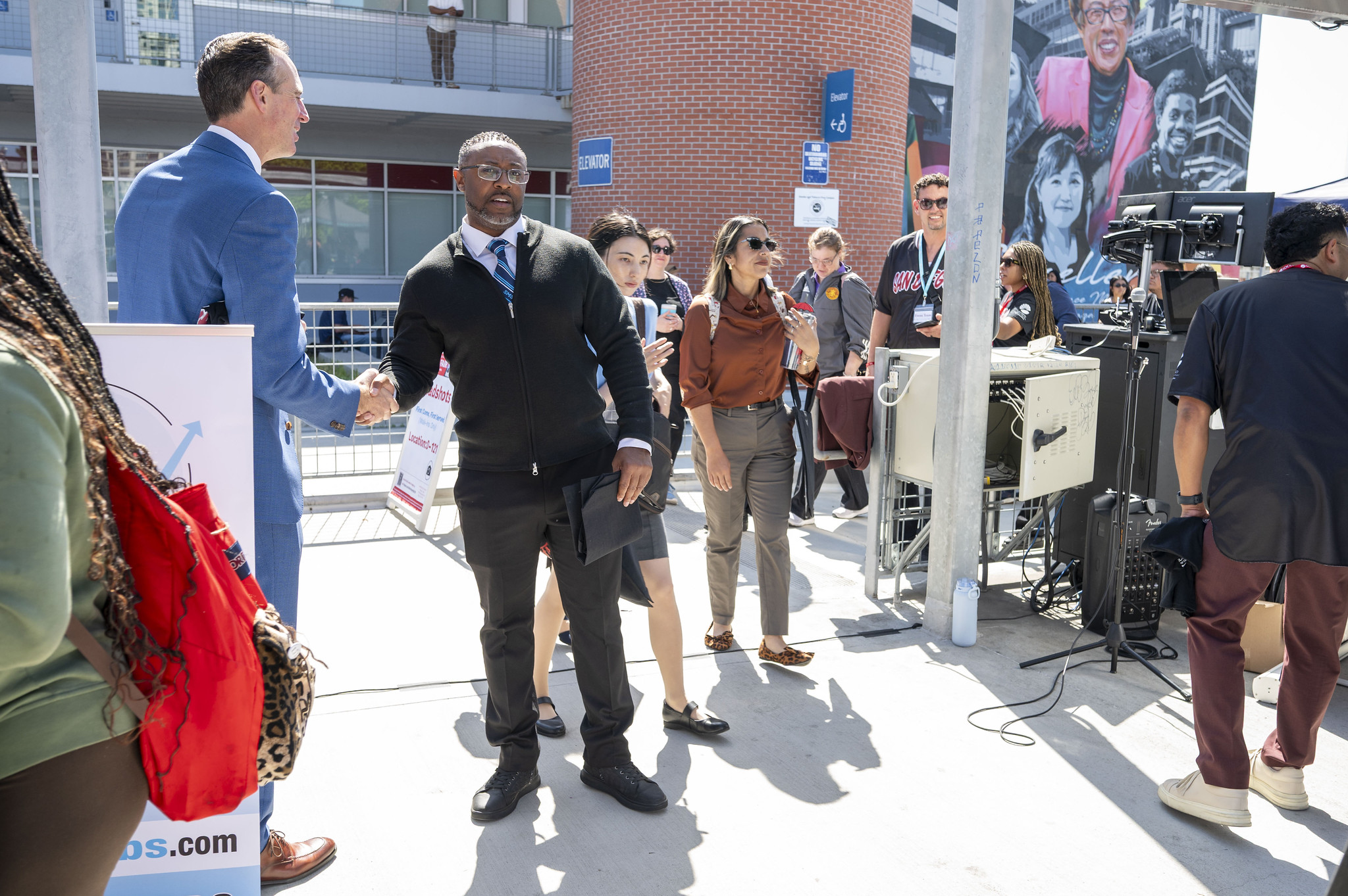 Chancellor Gregory Smith shakes hands with an attendee.
