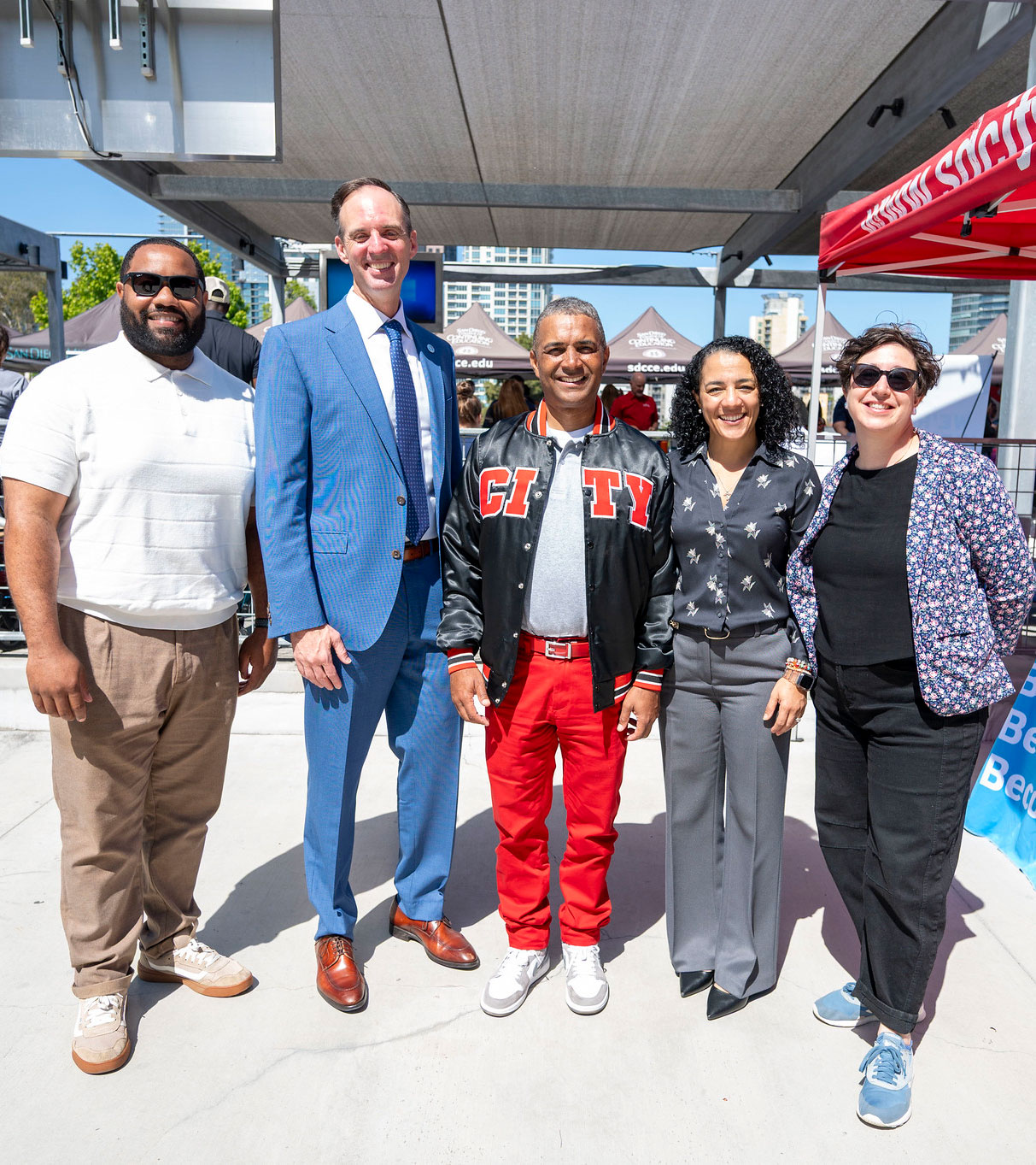 City College President Ricky Shabazz, center, with Chancellor Gregory Smith and 3 event coordinators.