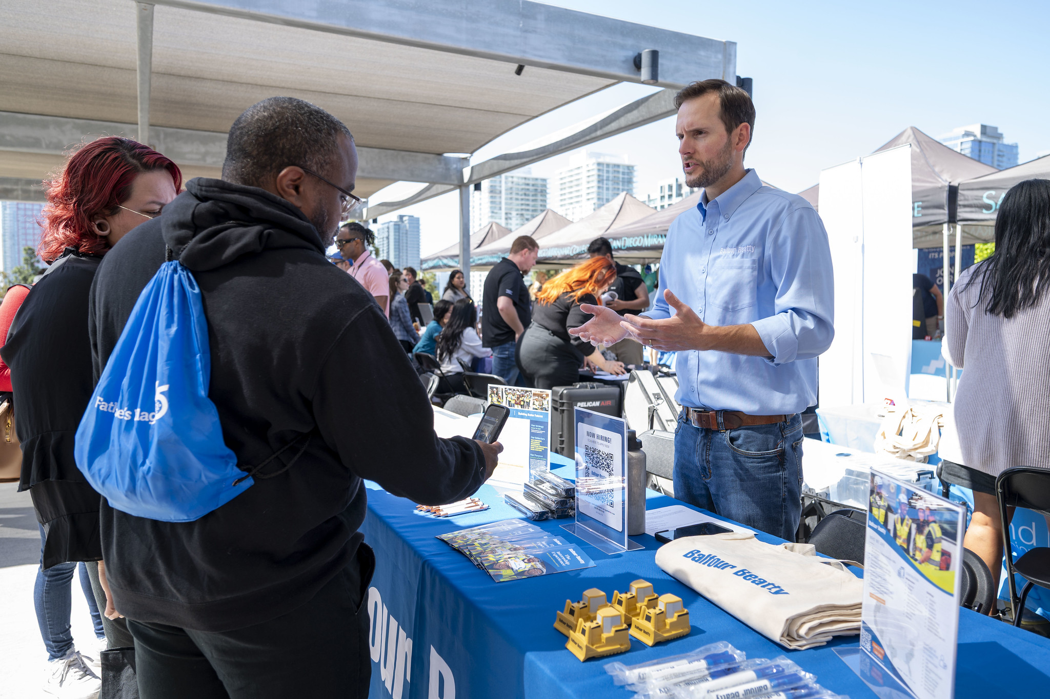 Two students stop by a booth at the career fair.