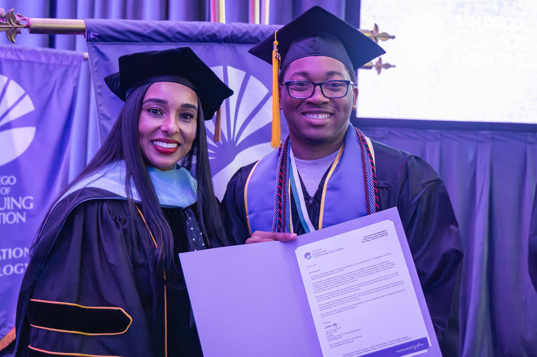College of Continuing Education President Tina King with a graduate holding a paper of special recognition.
