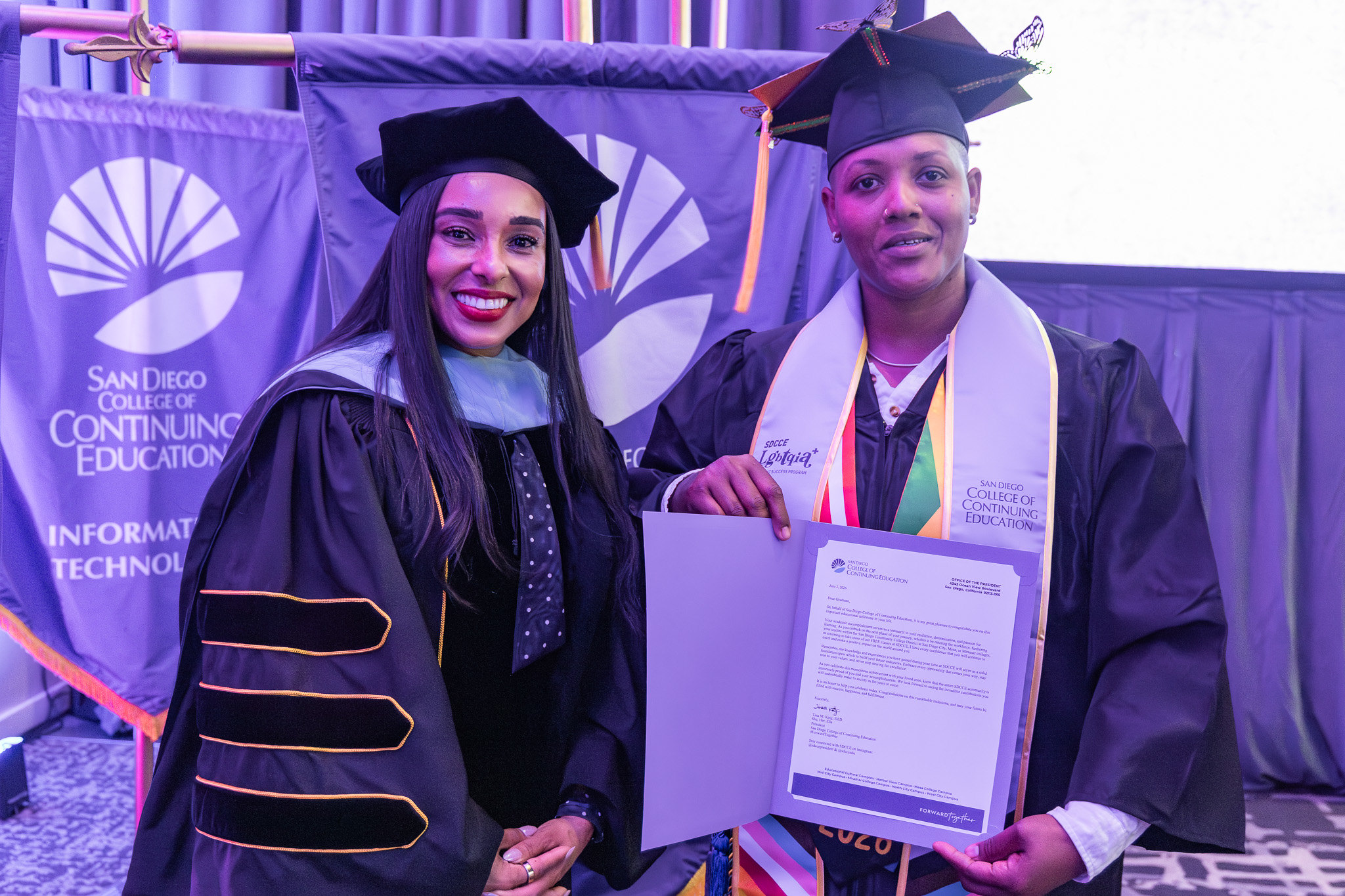 College of Continuing Education President Tina King with a graduate holding a paper of special recognition.