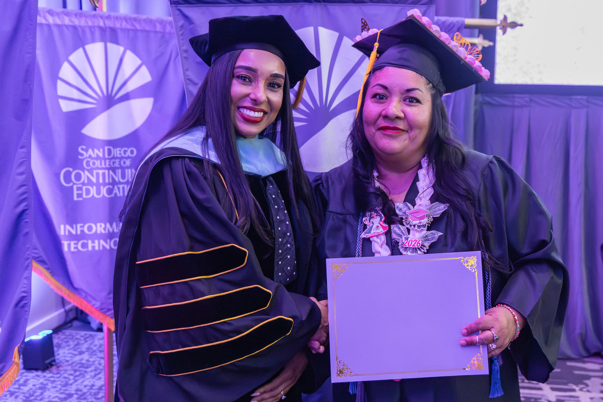 College of Continuing Education President Tina King with a graduate holding a paper of special recognition.