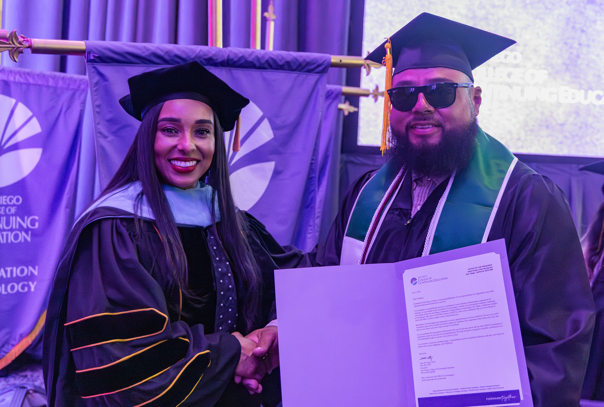College of Continuing Education President Tina King with a graduate holding a paper of special recognition.