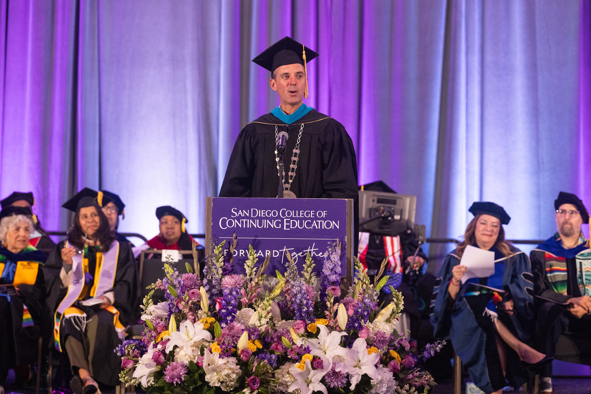 The chancellor speaks at a podium during the ceremony.