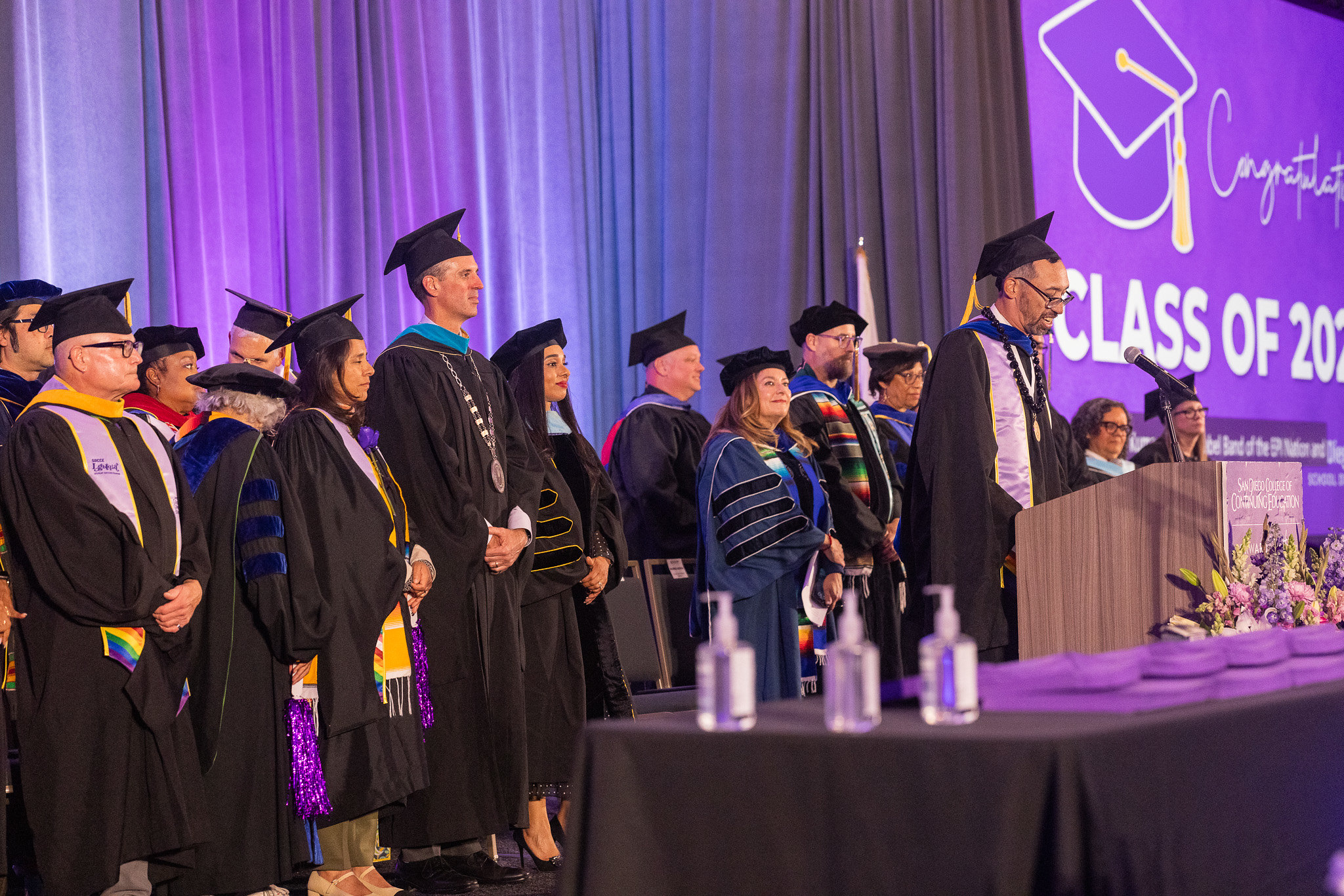 College and district leaders on stage at commencement.