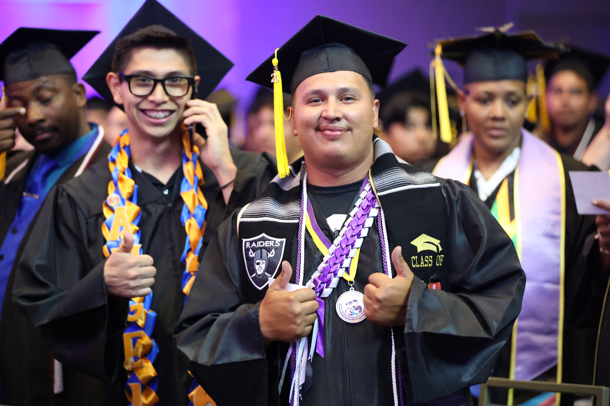Two grads wait to go on stage.