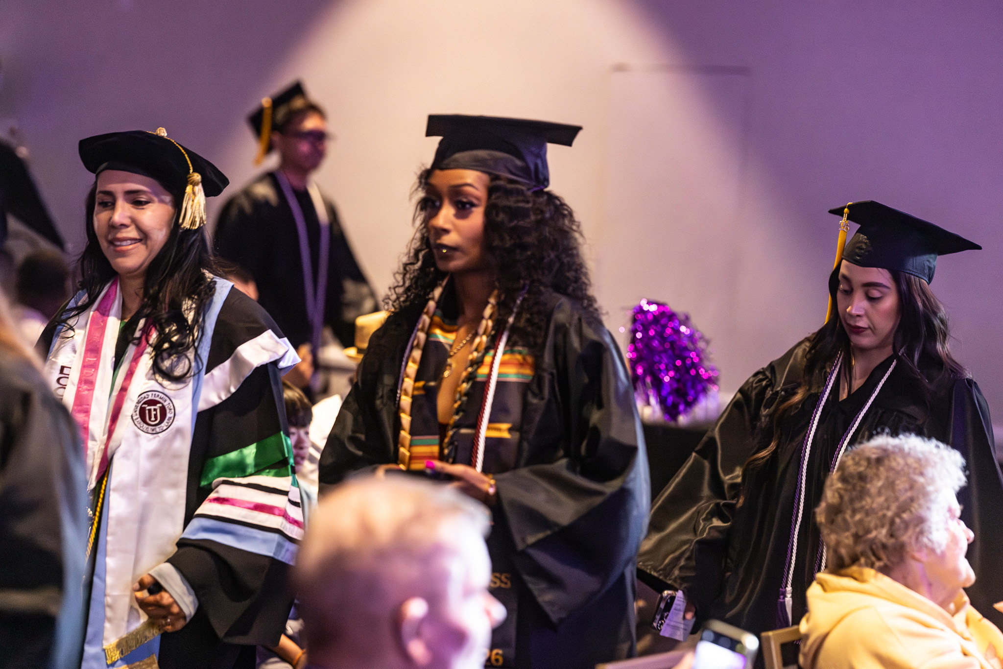 A graduate heads to her seat.