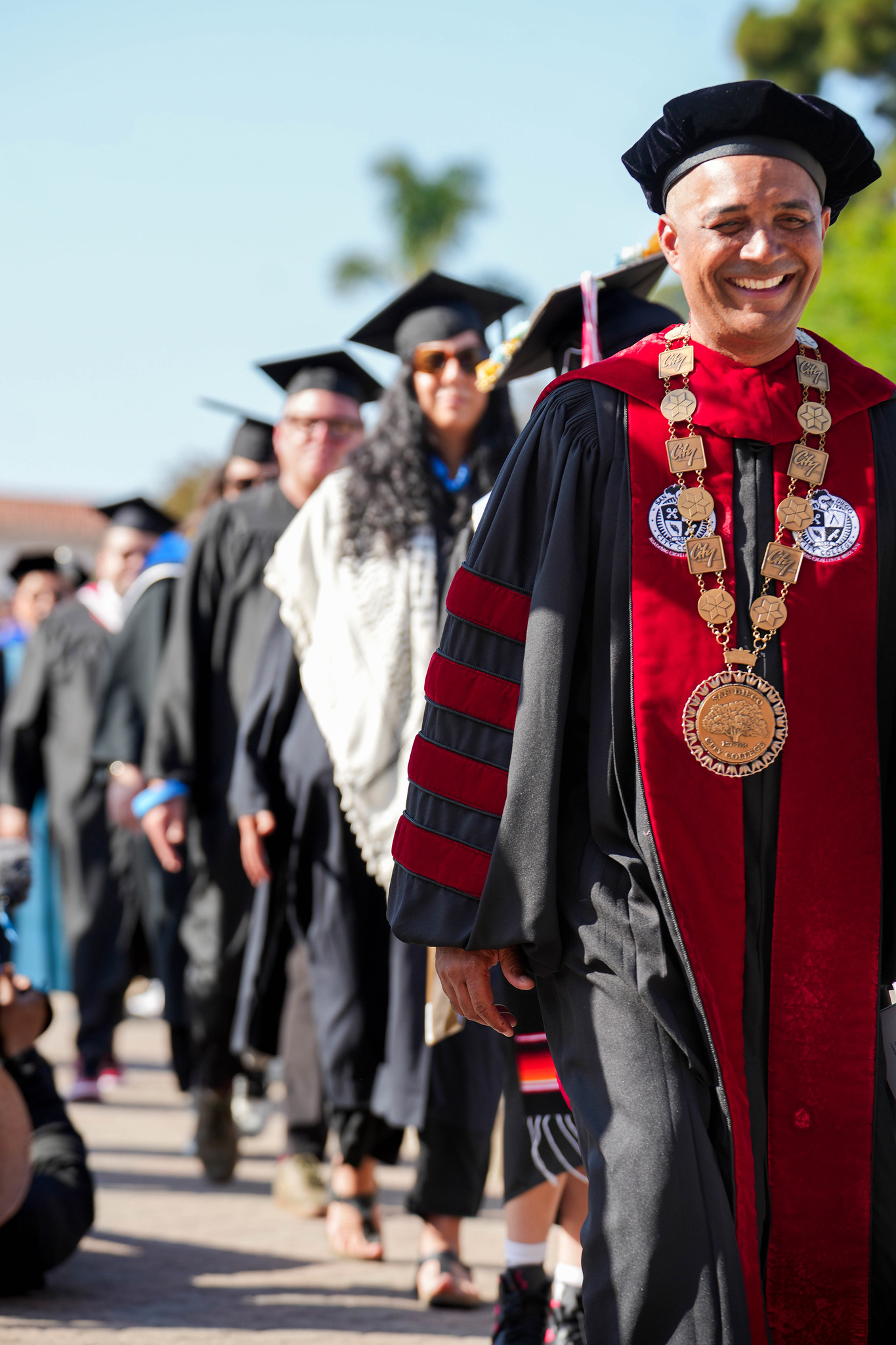 City College President Ricky Shabazz leads the way to the stage to start off the commencement ceremony.
