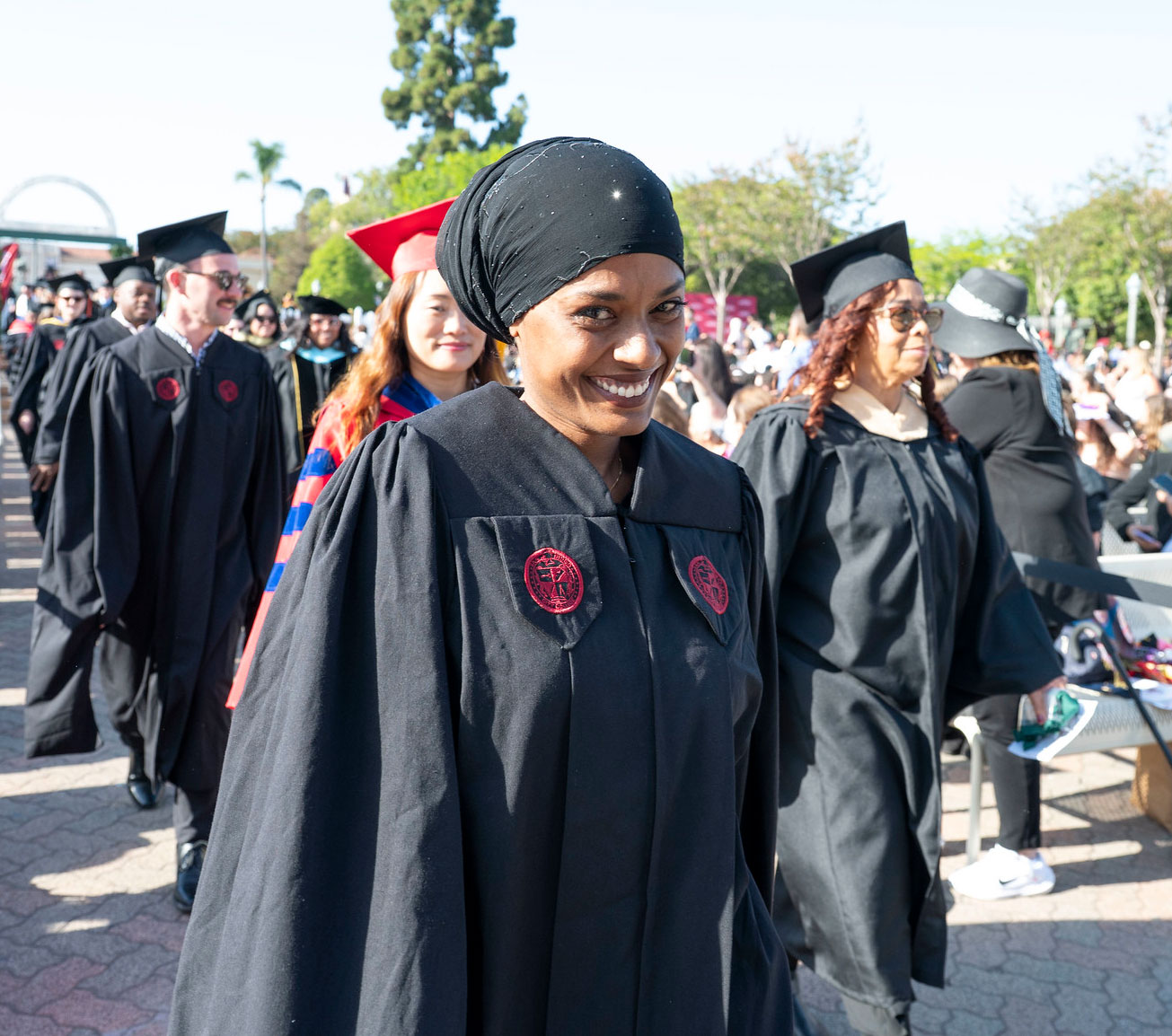A graduate smiles as she heads to her seat.&nbsp;