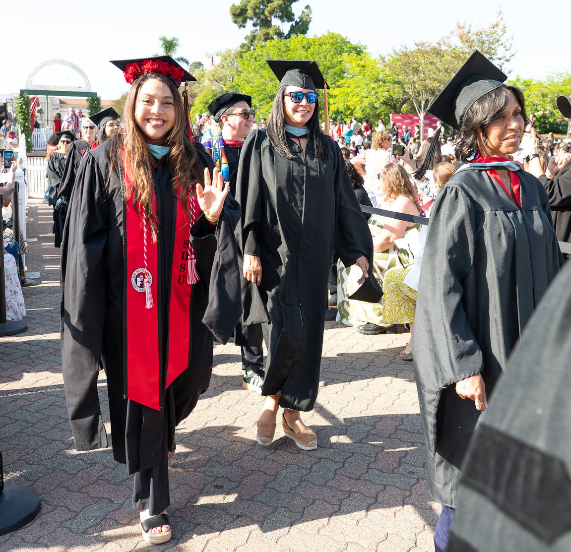 Two lines of graduates walking to their seats.&nbsp;
