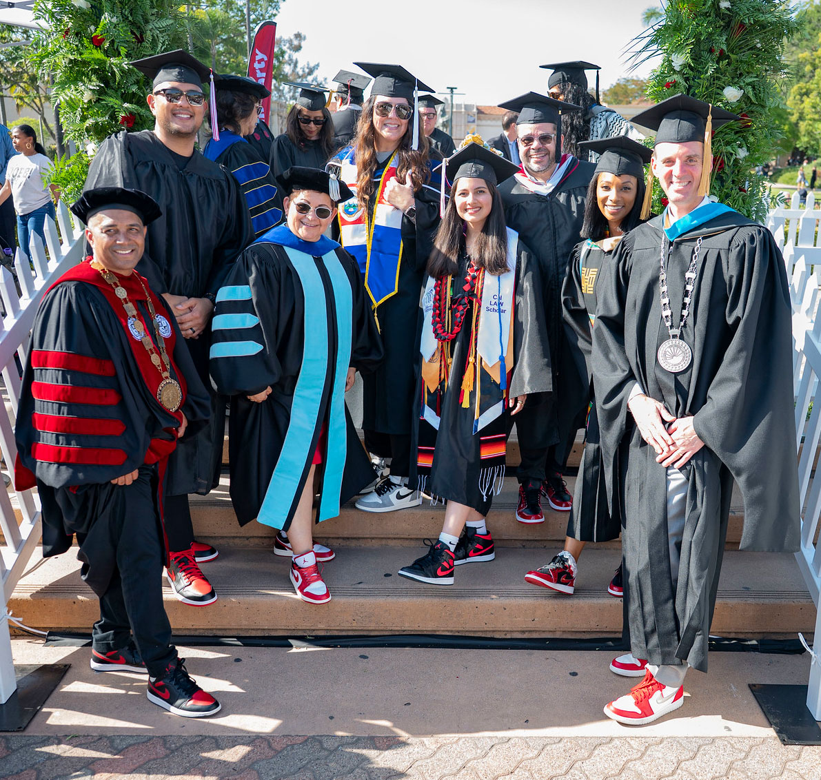 Eight City College and District officials show off their matching red and white sneakers before heading to the stage.&nbsp;