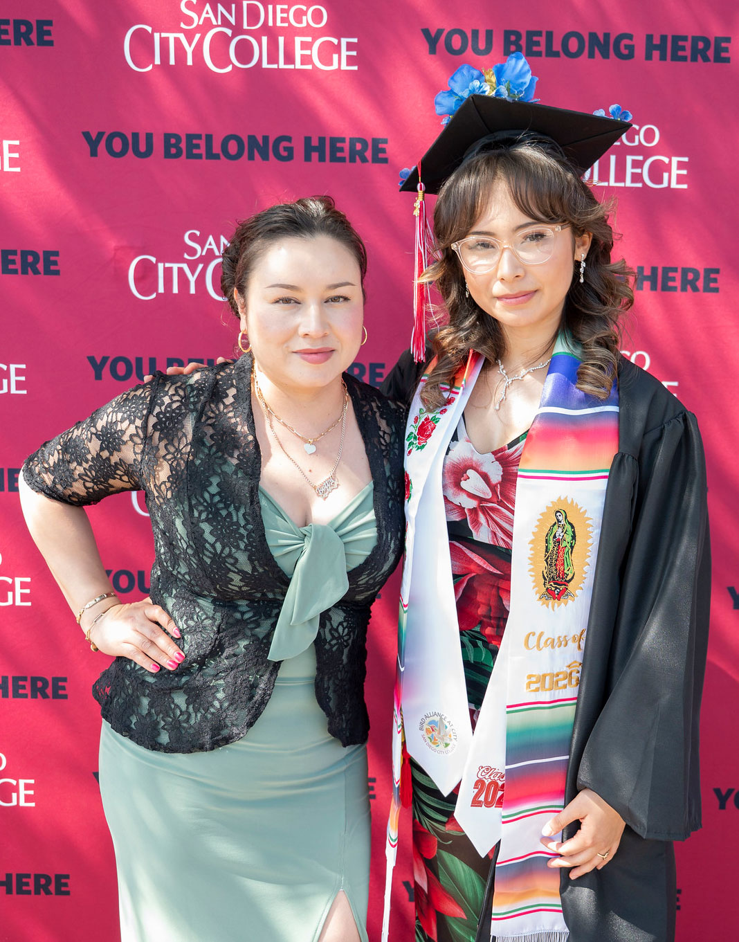A graduate poses with a family member.