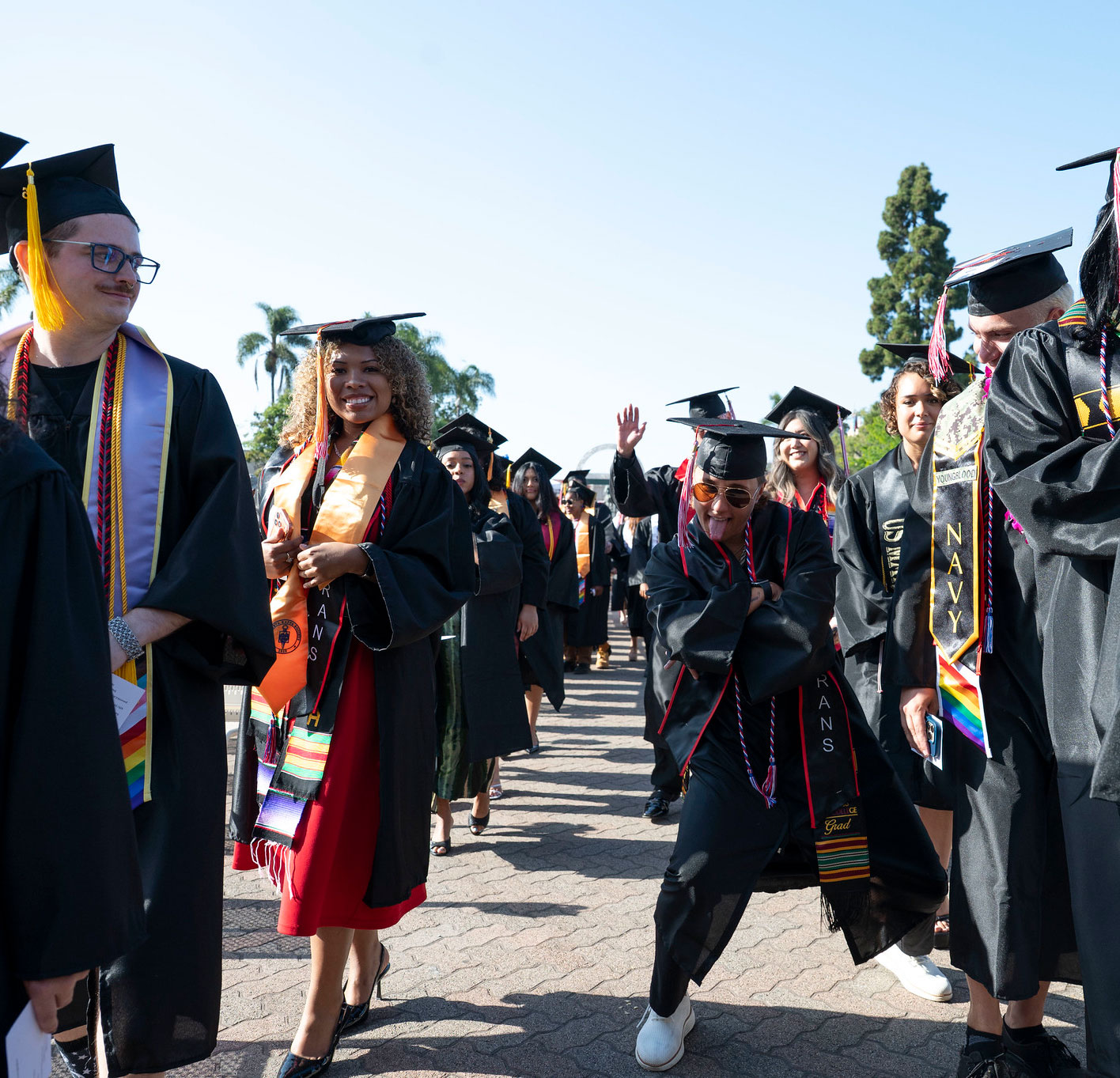 Two lines of students walk to their seats.&nbsp;