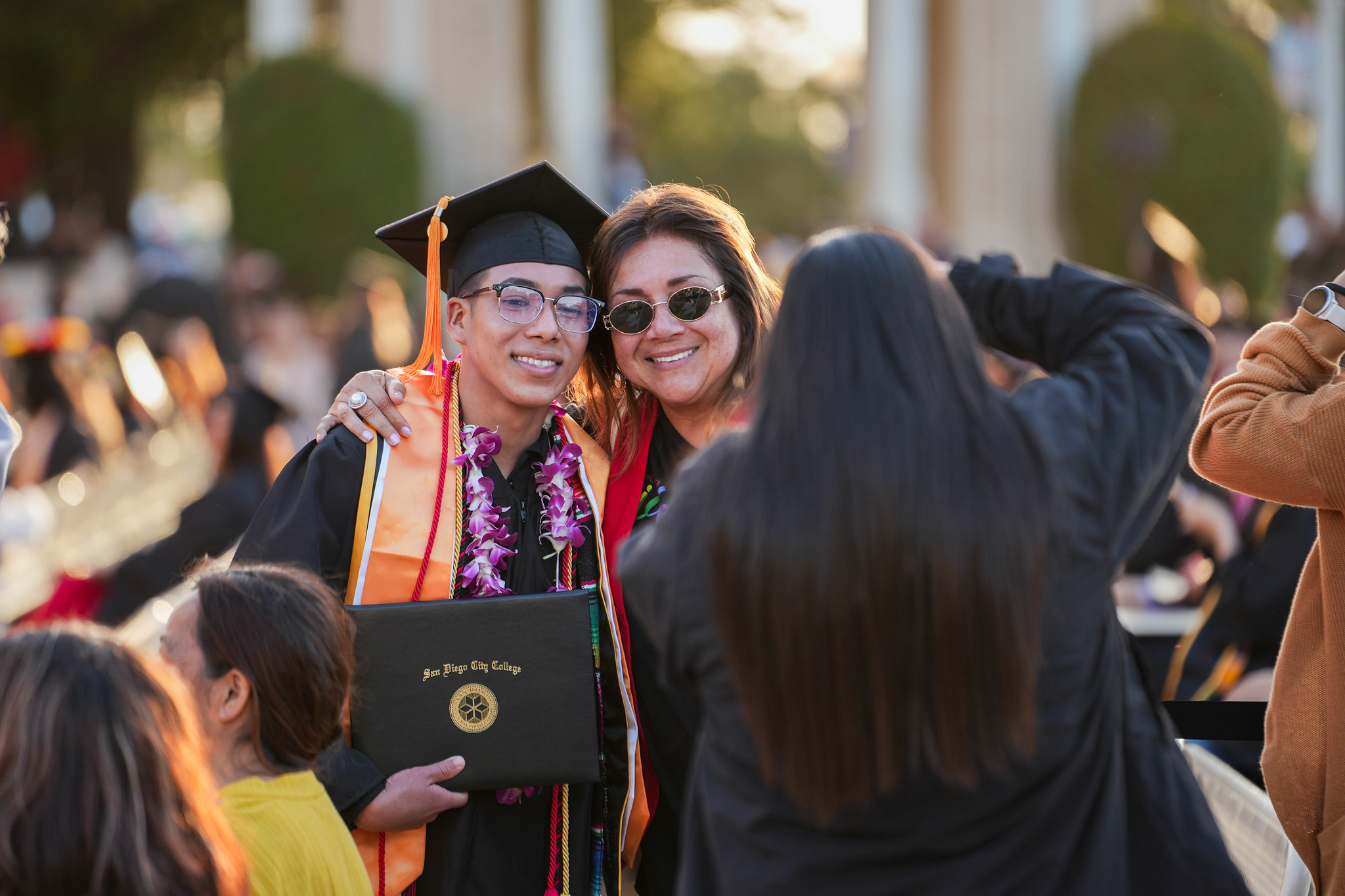 A graduate poses with a family member.&nbsp;
