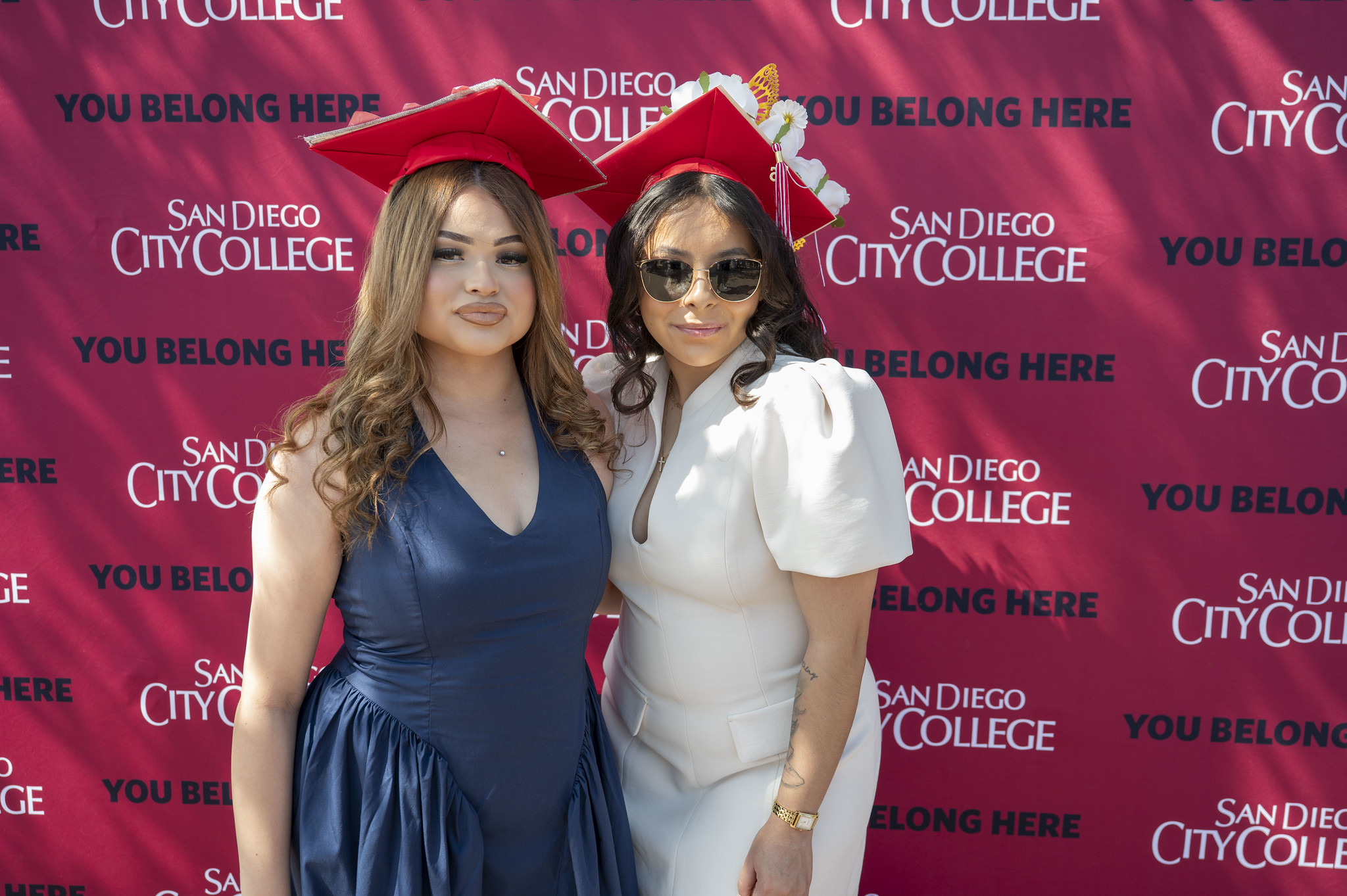 Two graduates pose together before the start of commencement.