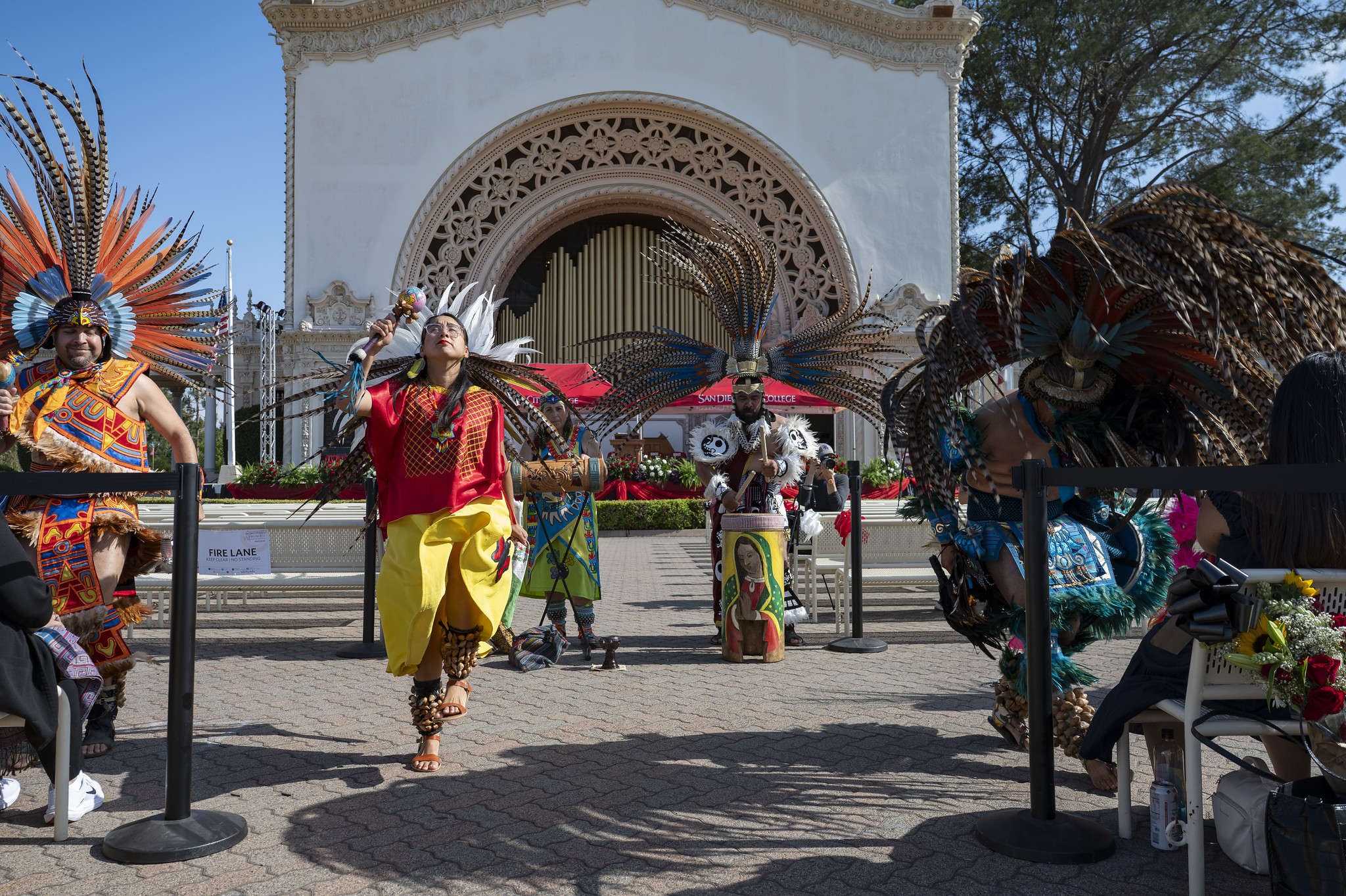 Native American dancers with feather crowns perform.&nbsp;