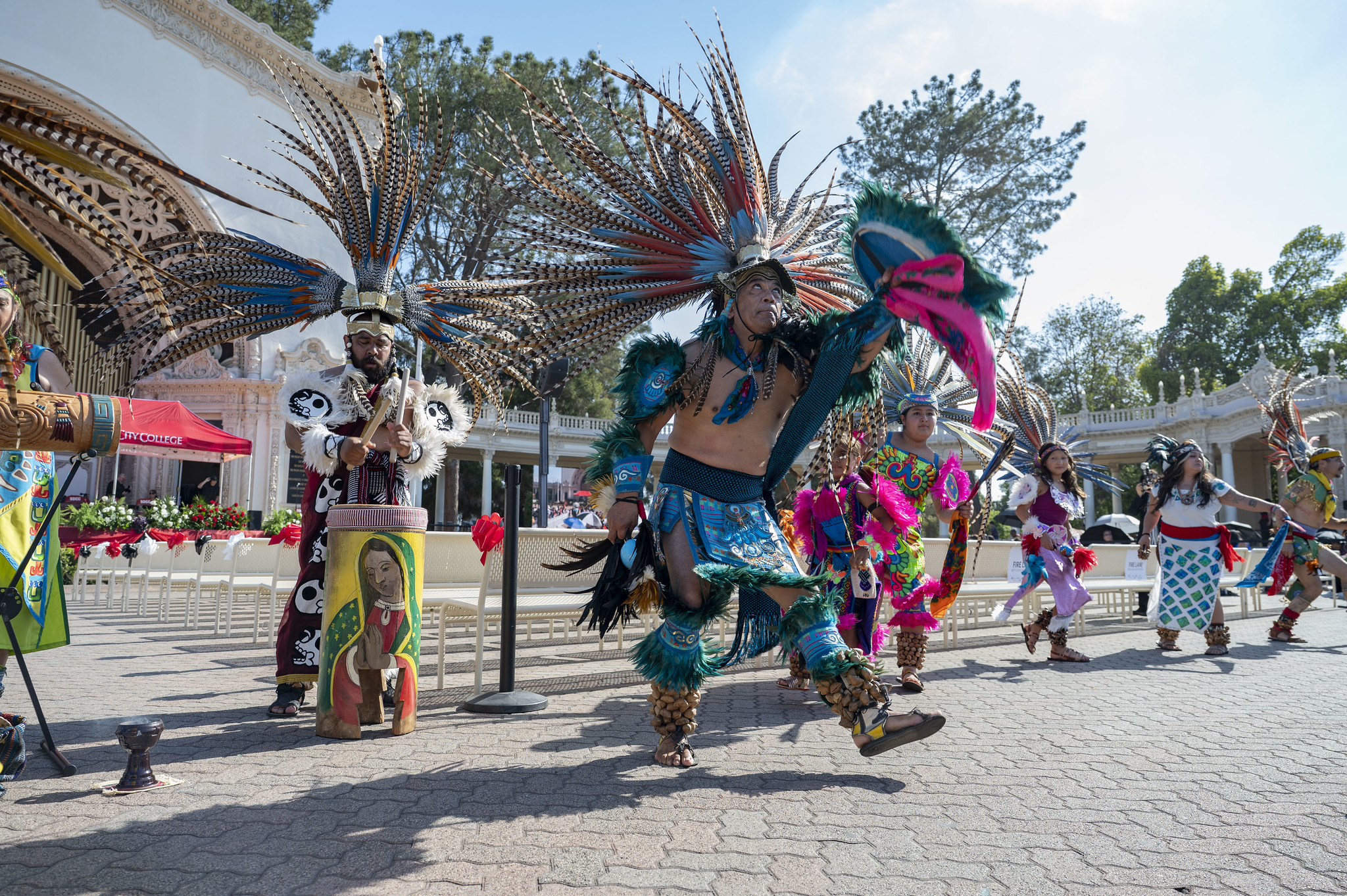Native American dancers with feather crowns perform.&nbsp;