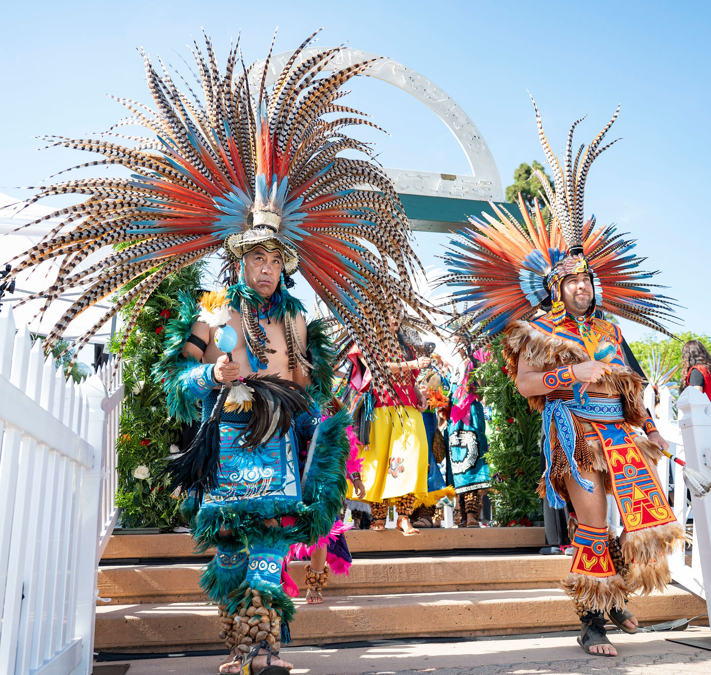 Native American dancers with feather crowns perform.&nbsp;