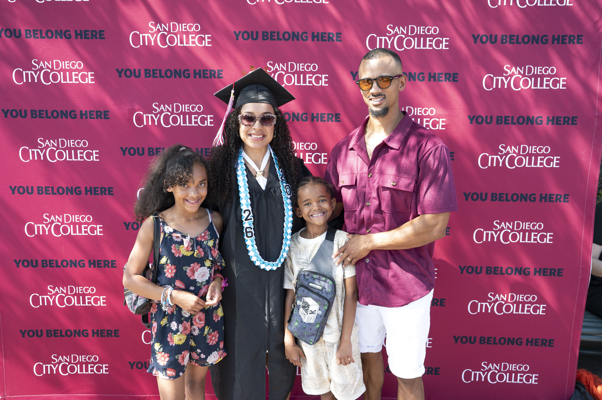 A graduate poses with her family