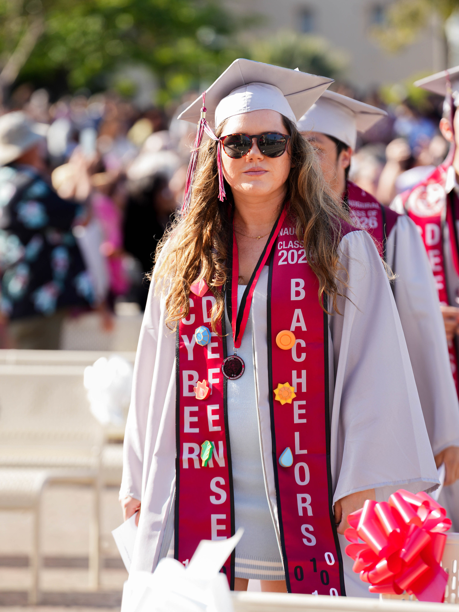 A graduate in the cyber defense bachelor's degree program heads to her seat.&nbsp;