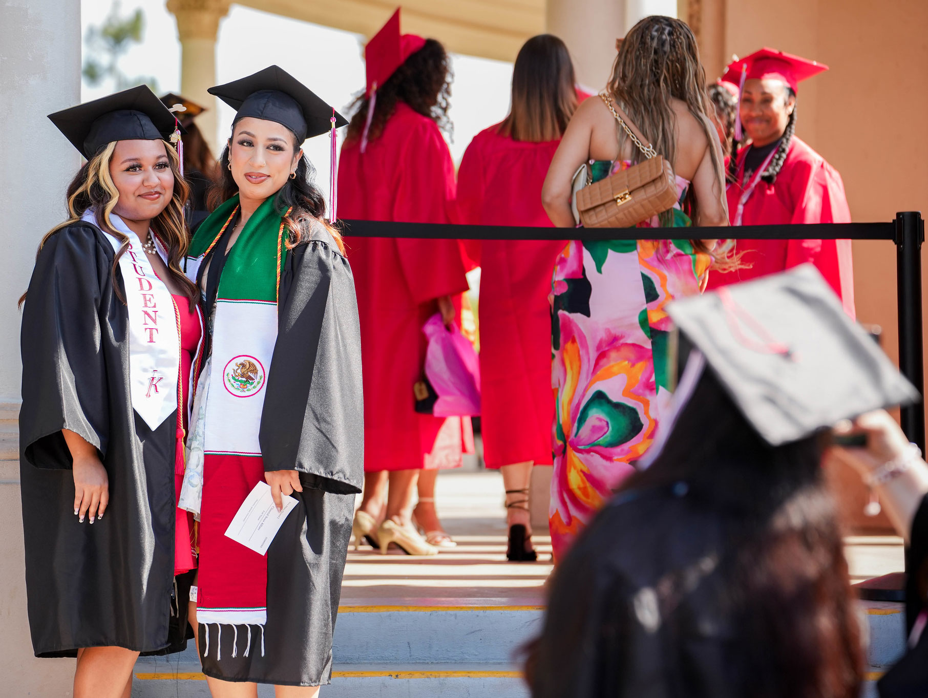 Two graduates at commencement.