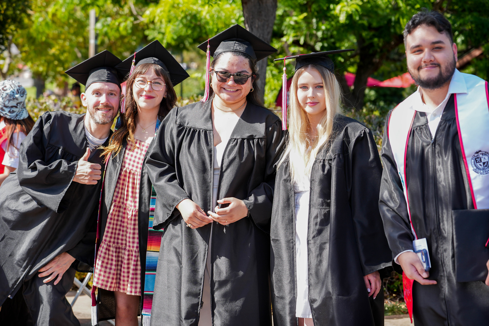 Five grads take a group photo.