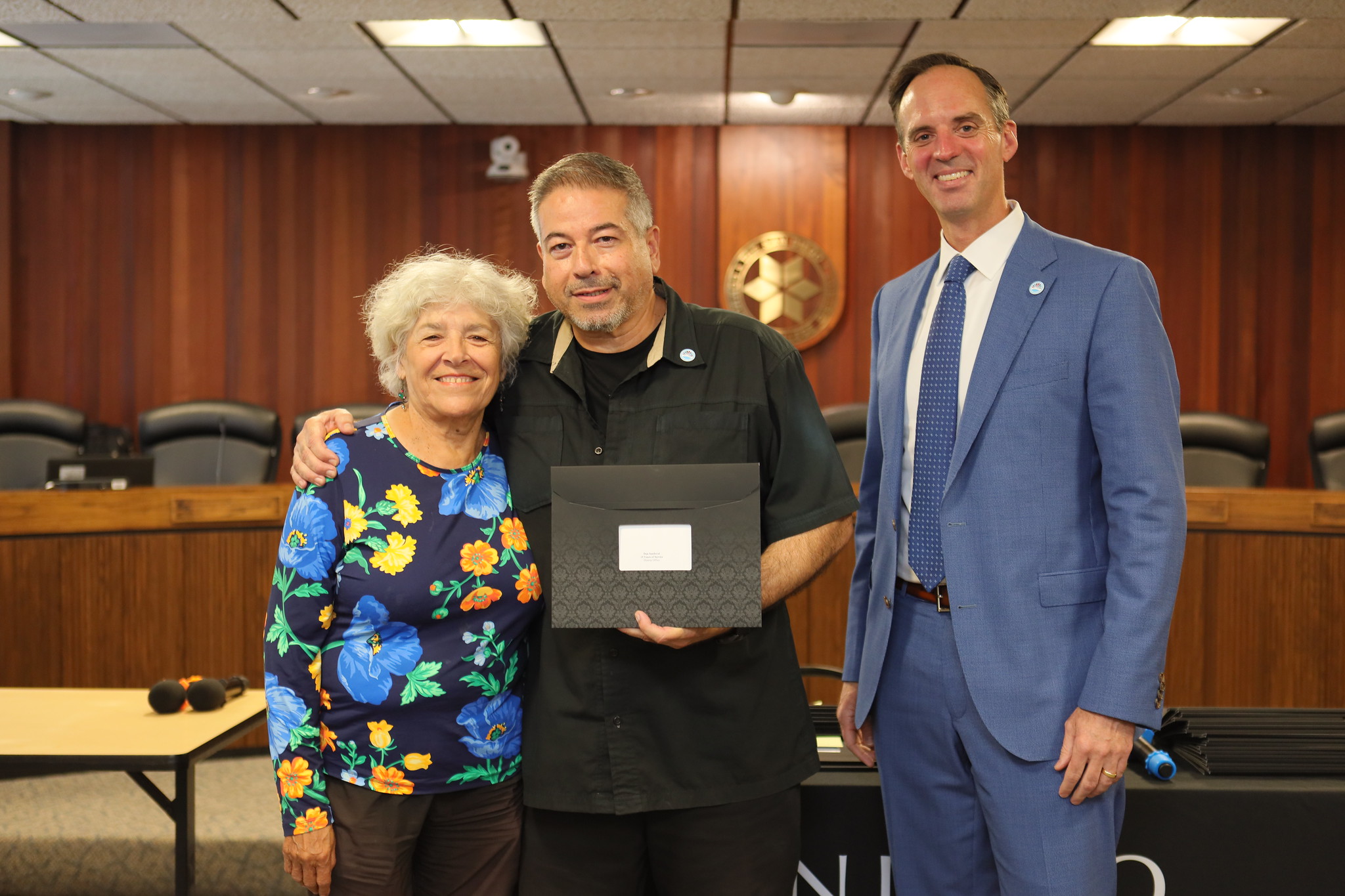 
Dan Sandoval is with Trustee Maria Nieto Senour and Chancellor Gregory Smith as he is presented with his service certificate.
