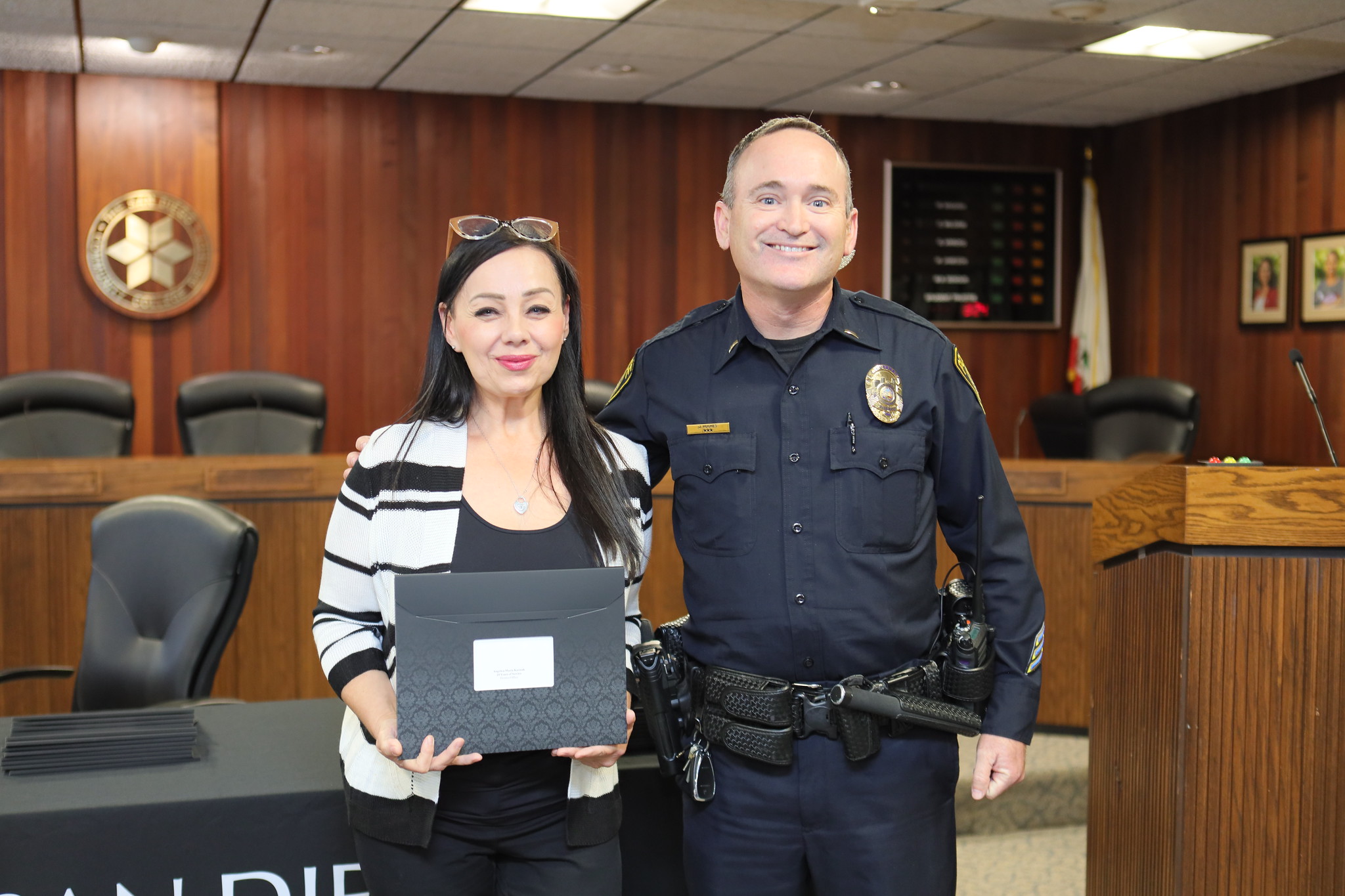 
An employee is presented with their service certificate.
