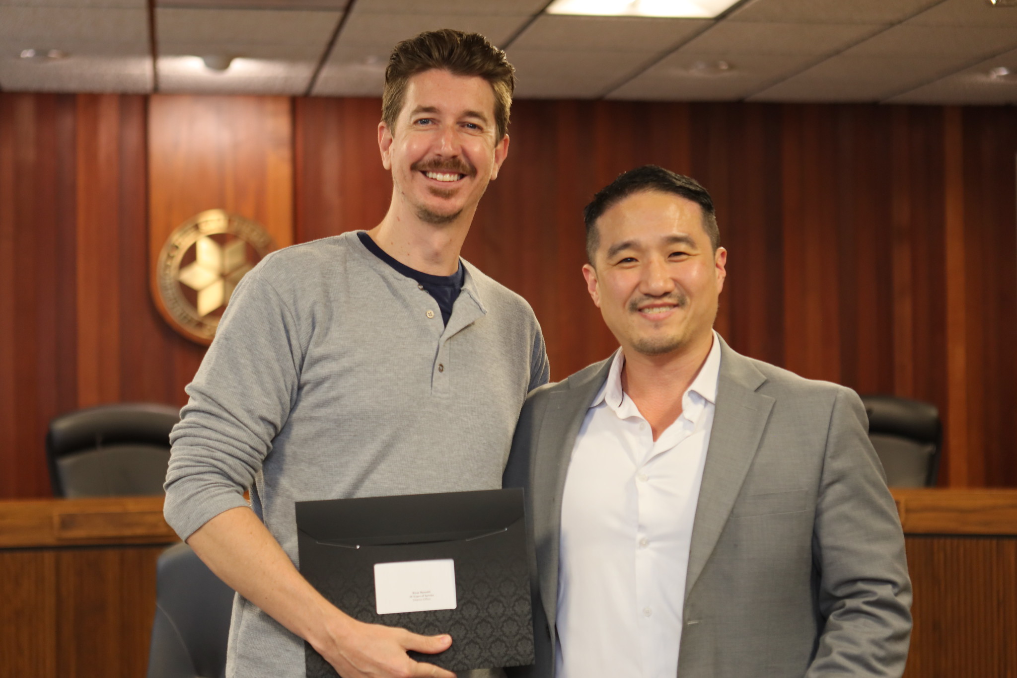
An employee is presented with their service certificate.
