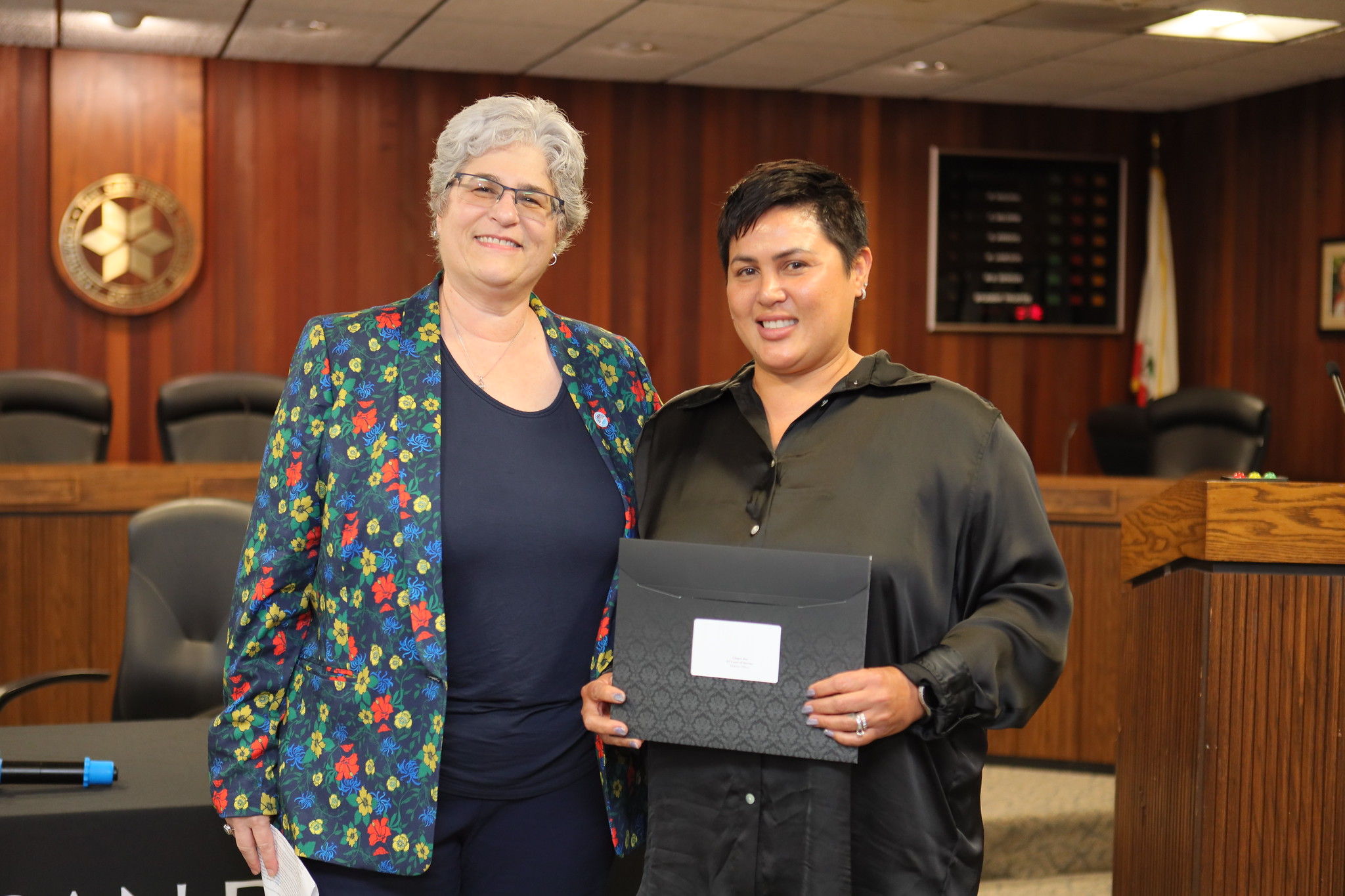 
Ginger Jeu is presented with a service certificate by Vice Chancellor Michelle Fischthal.
