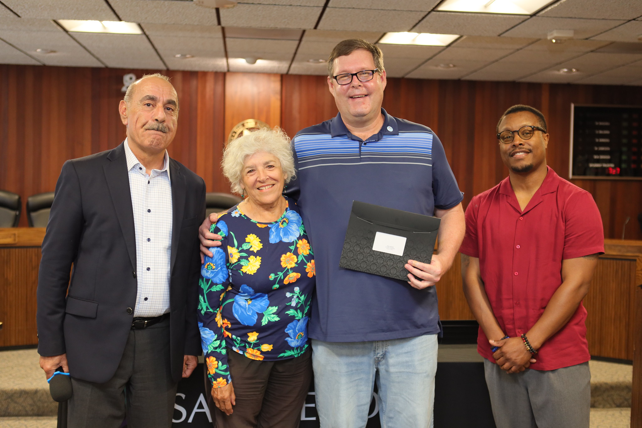 
John Kalchick is presented with a service award. He is photographed with, from left, Associate Vice Chancellor of IT Antoine Andari, Trustee Maria Nieto Senour, and Vice Chancellor of People, Culture and Technology Jared Burns.

