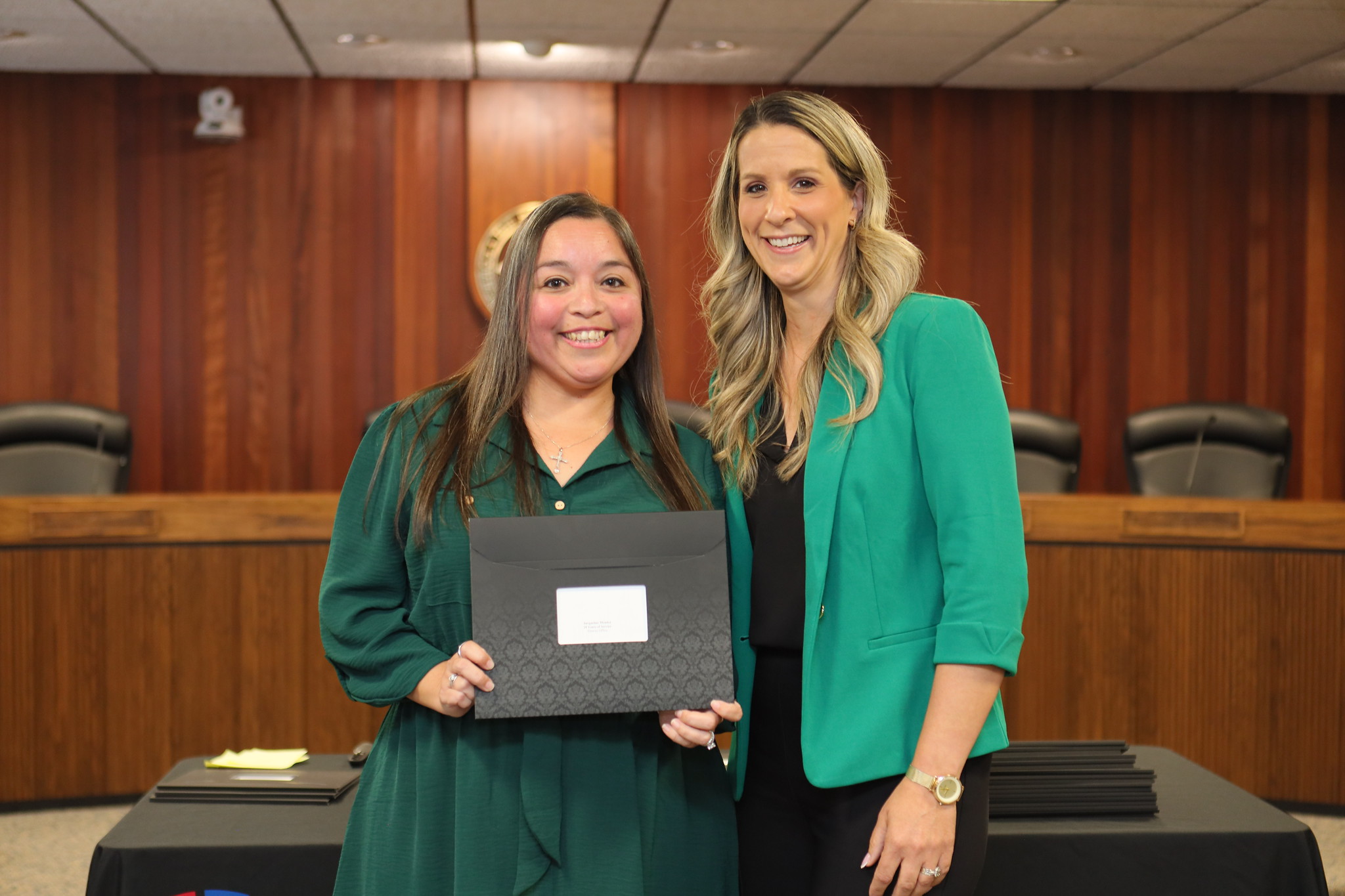 
An employee is presented with their service certificate.
