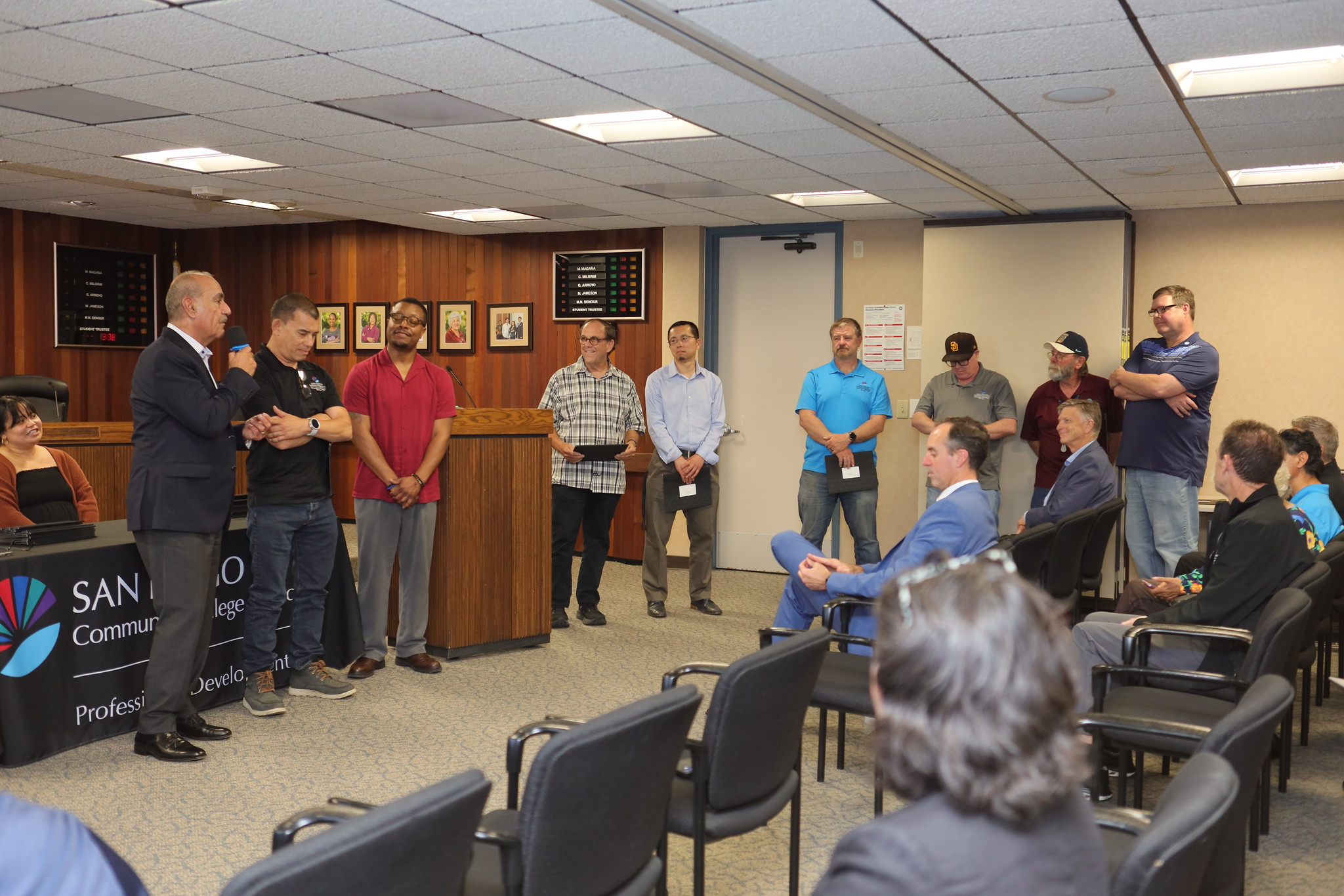 
An employee is presented with their service certificate.
