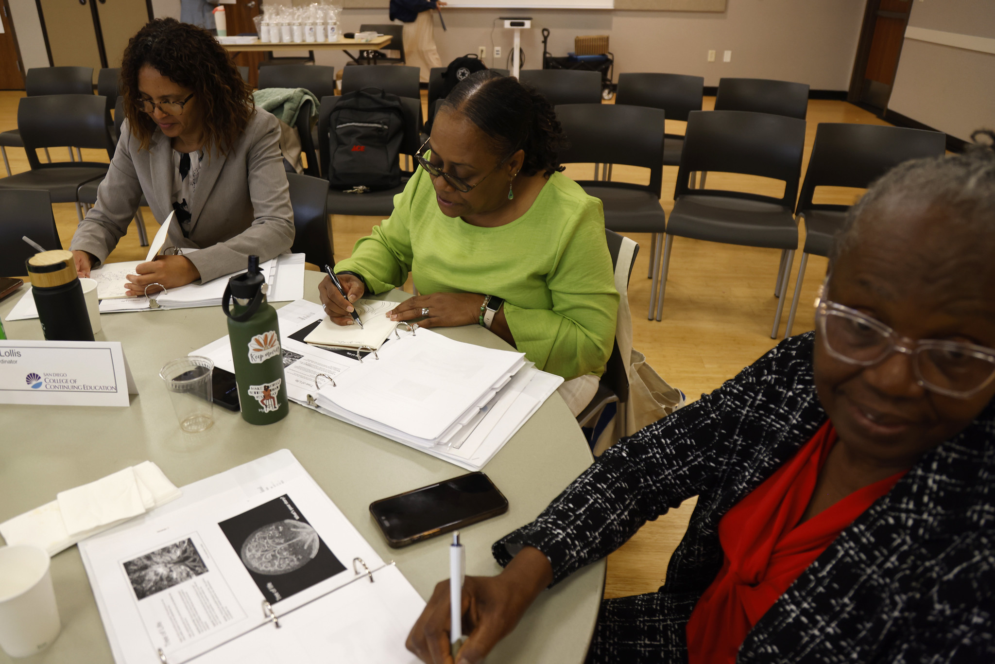 Attendees of the academy seated at a table.