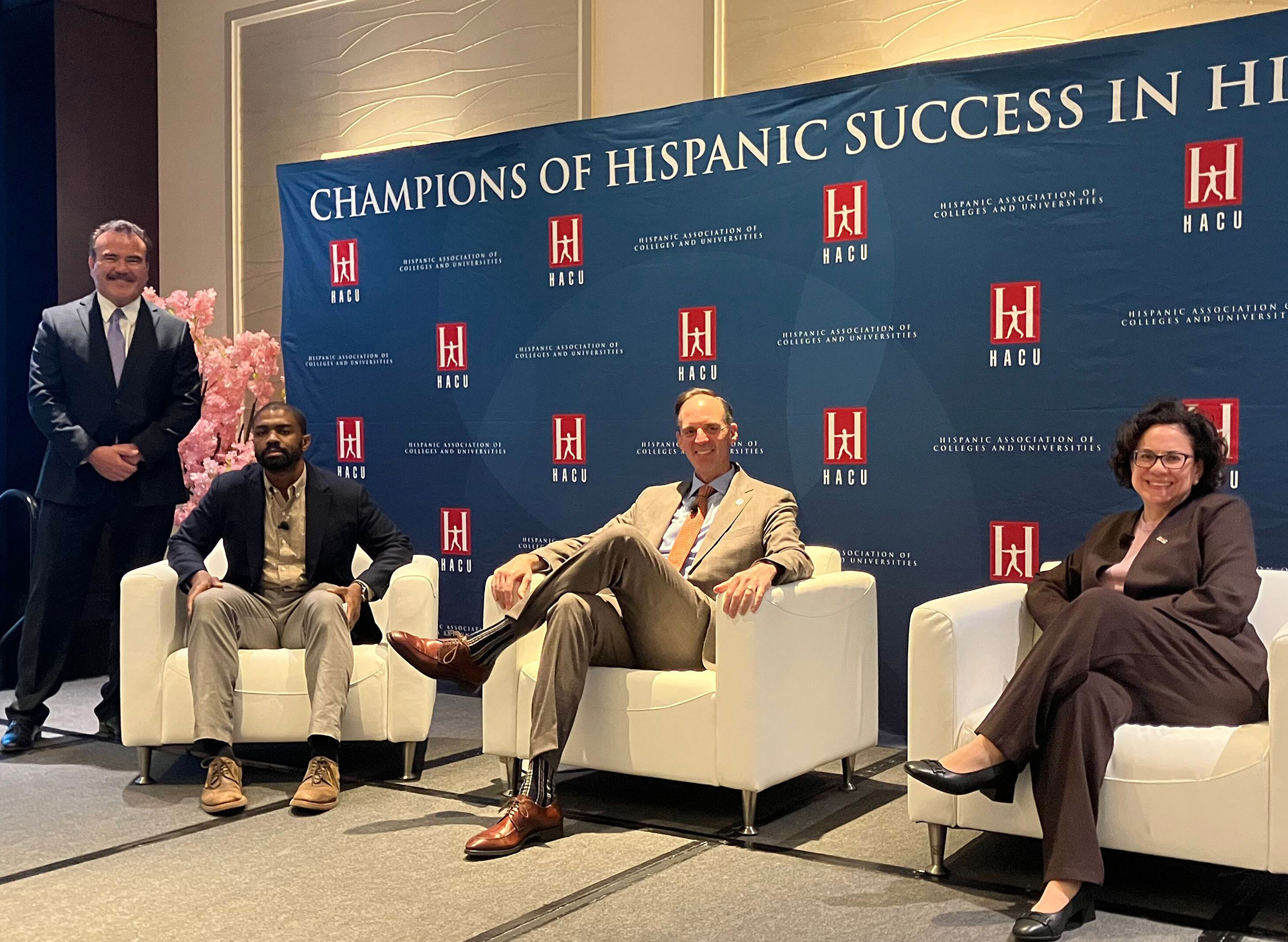 Chancellor Gregory Smith and three others on stage at the forum.