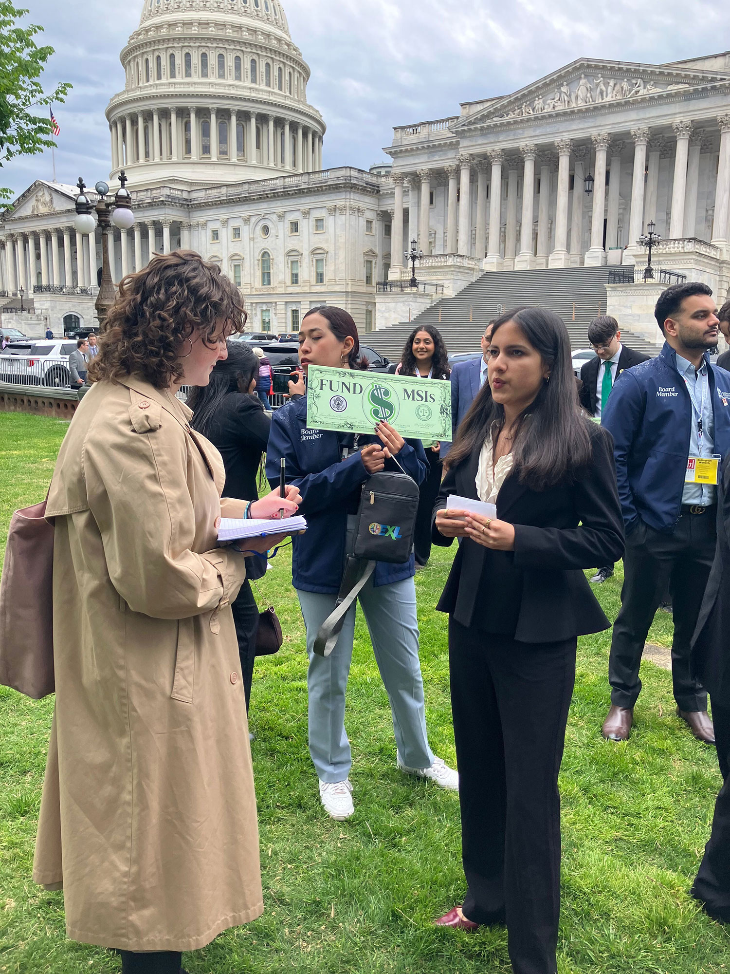 Student Trustee Celina Martinez speaks to a reporter after a news conference.