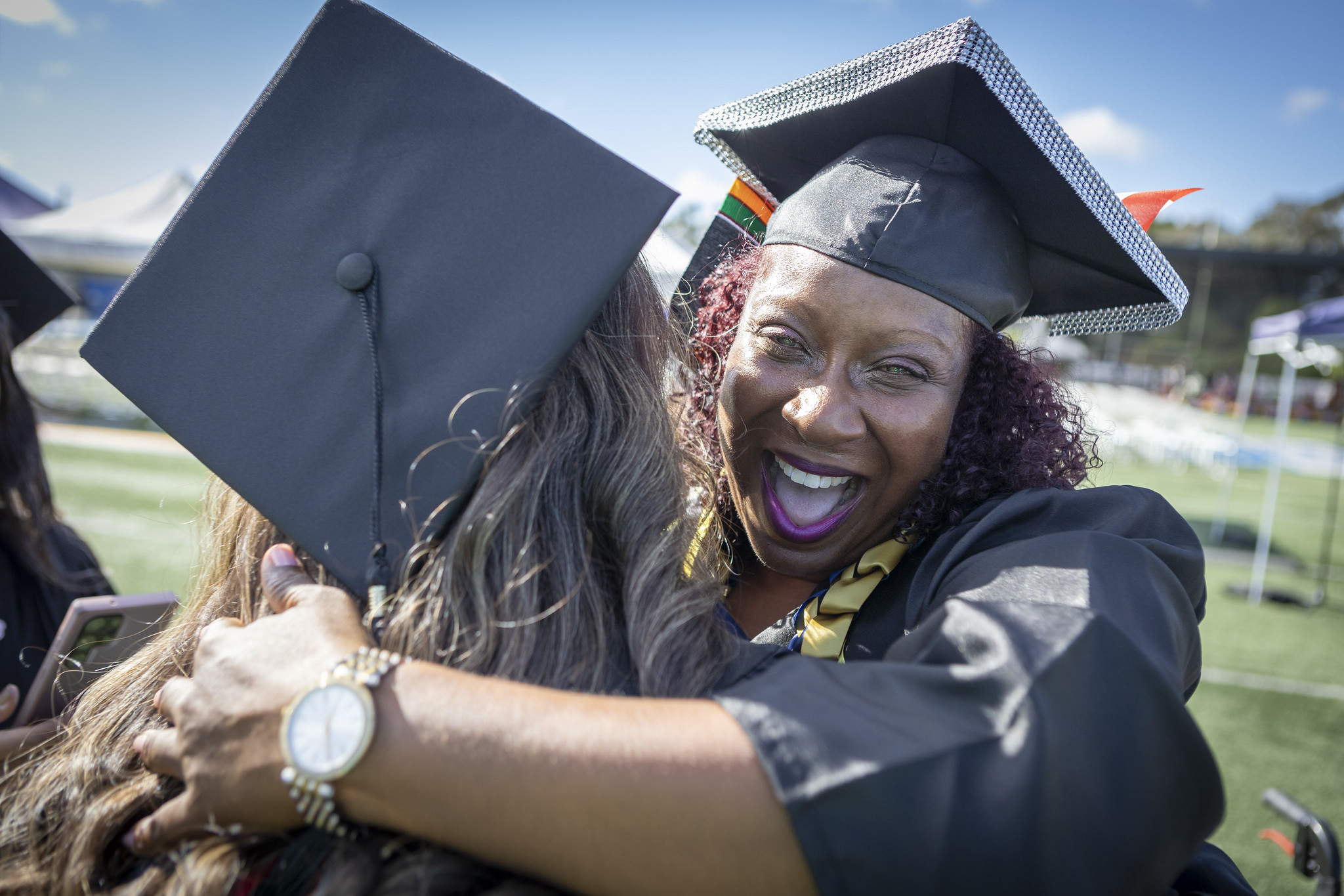 Two grads hugging.&nbsp;