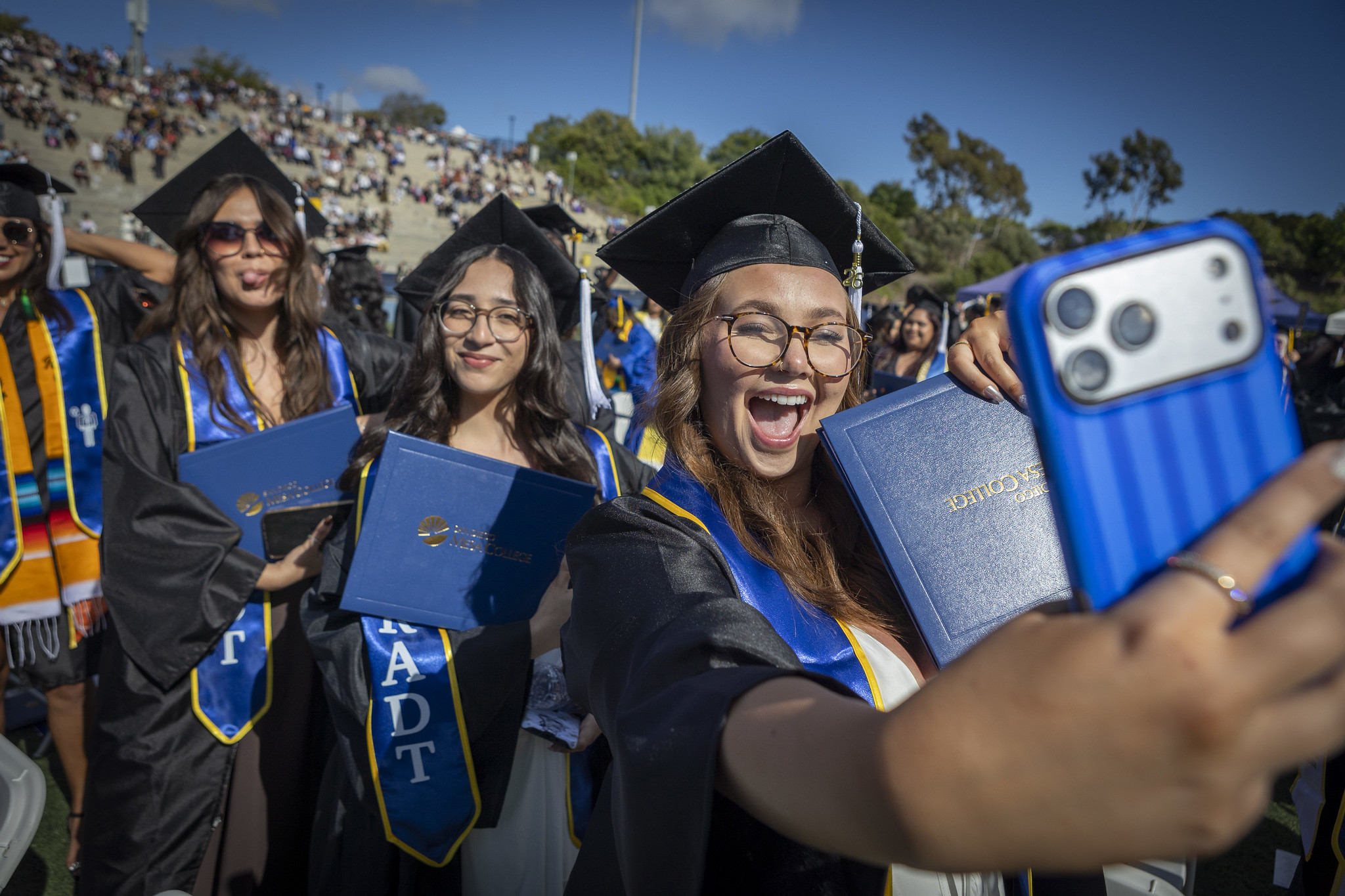 A grad takes a selfie with her degree.&nbsp;