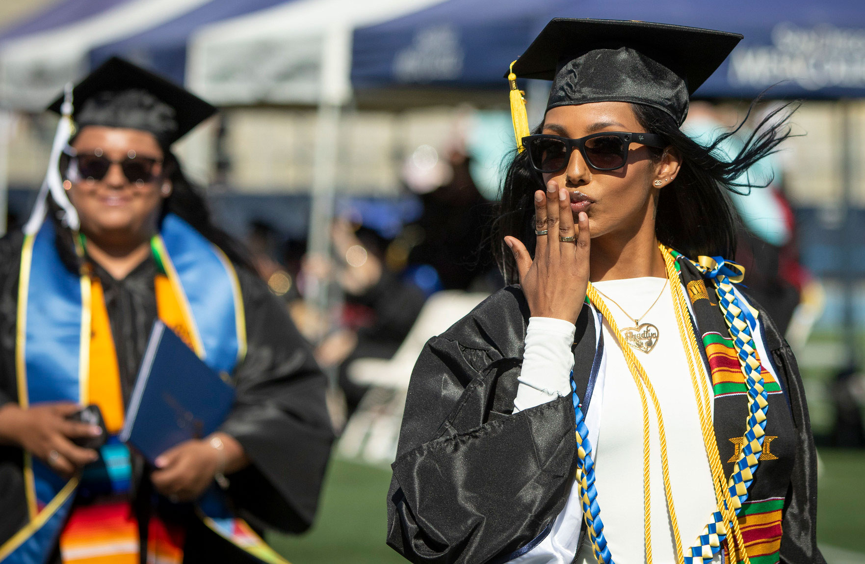 A graduate blows a kiss to the audience.&nbsp;