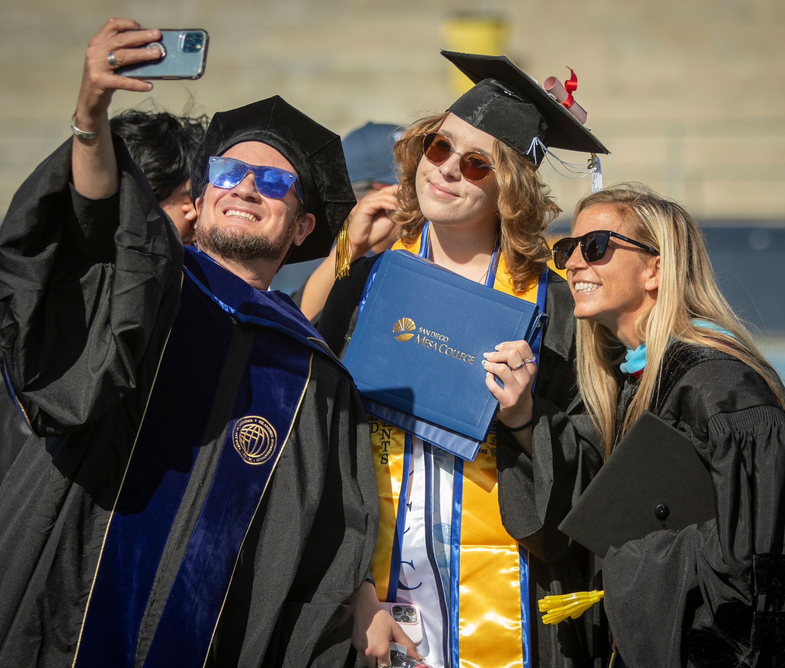 Three grads take a selfie.&nbsp;