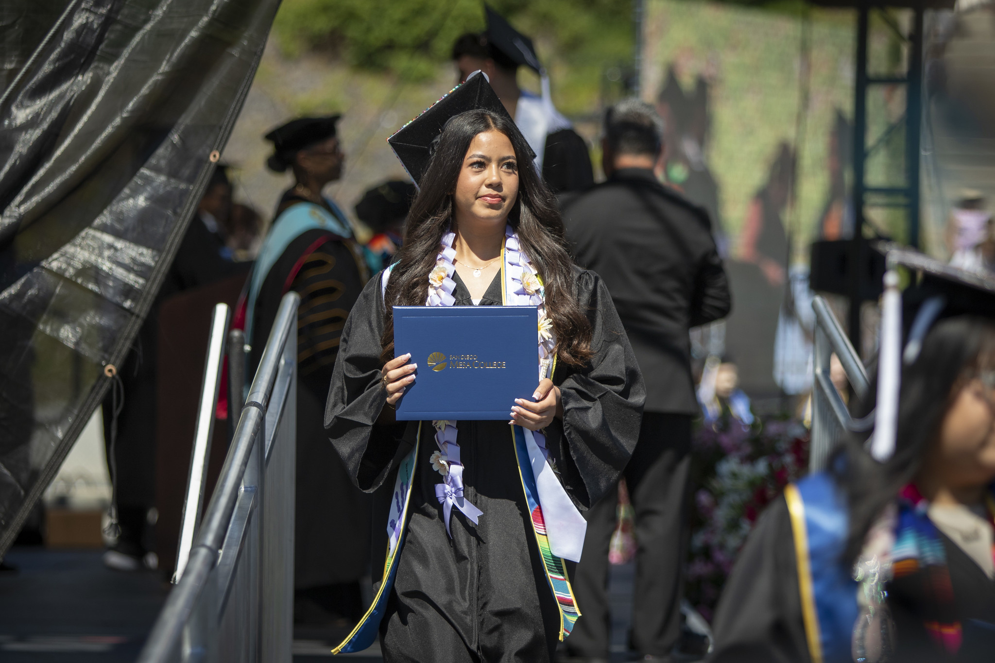 A student leaving the stage with their degree.&nbsp;